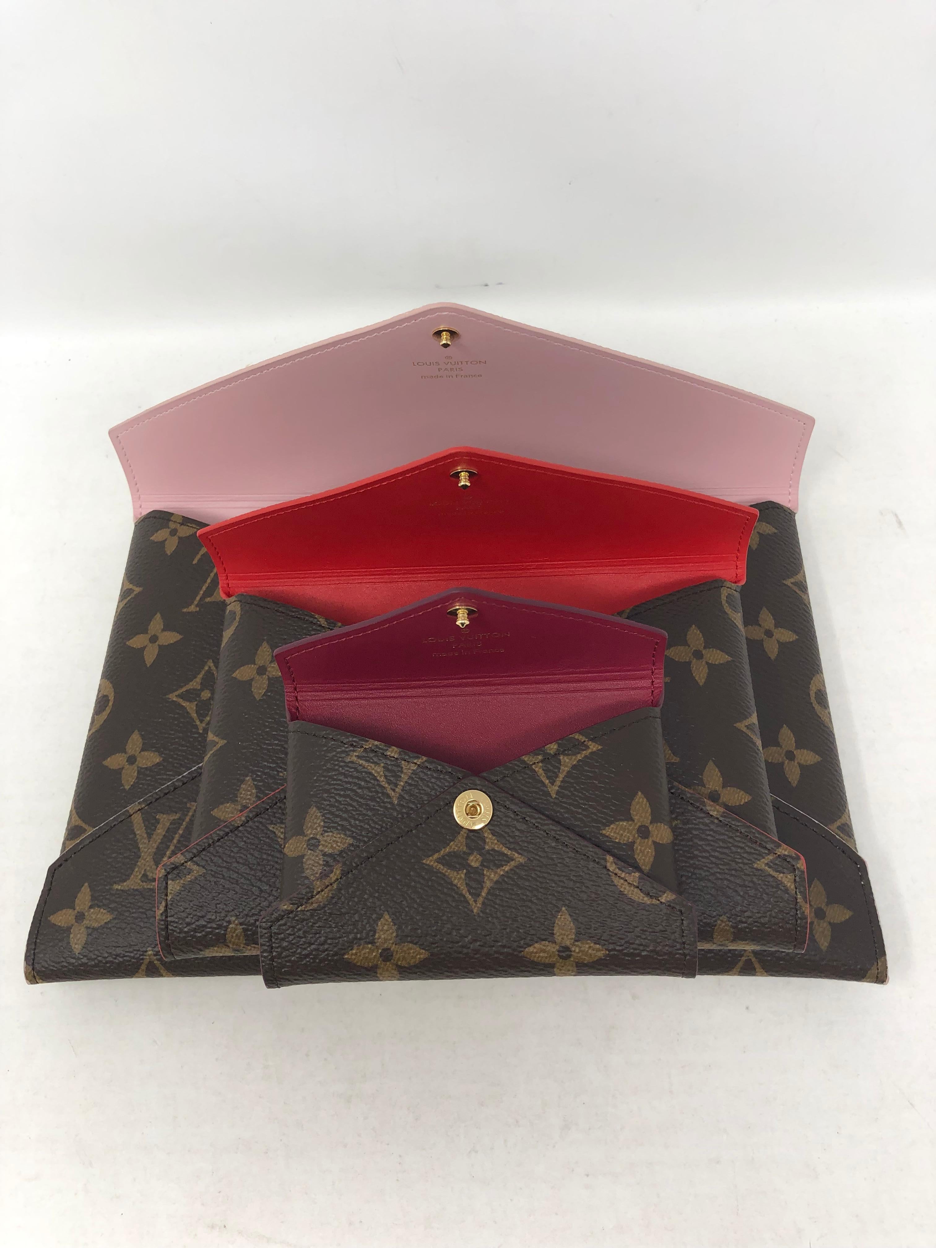 Louis Vuitton Pochette Kirigami set. Three envelope style clutches that fit together like a Russian nesting doll. Pink, red and purple interior. Brand new. Includes dust cover and box. Guaranteed authentic. 
