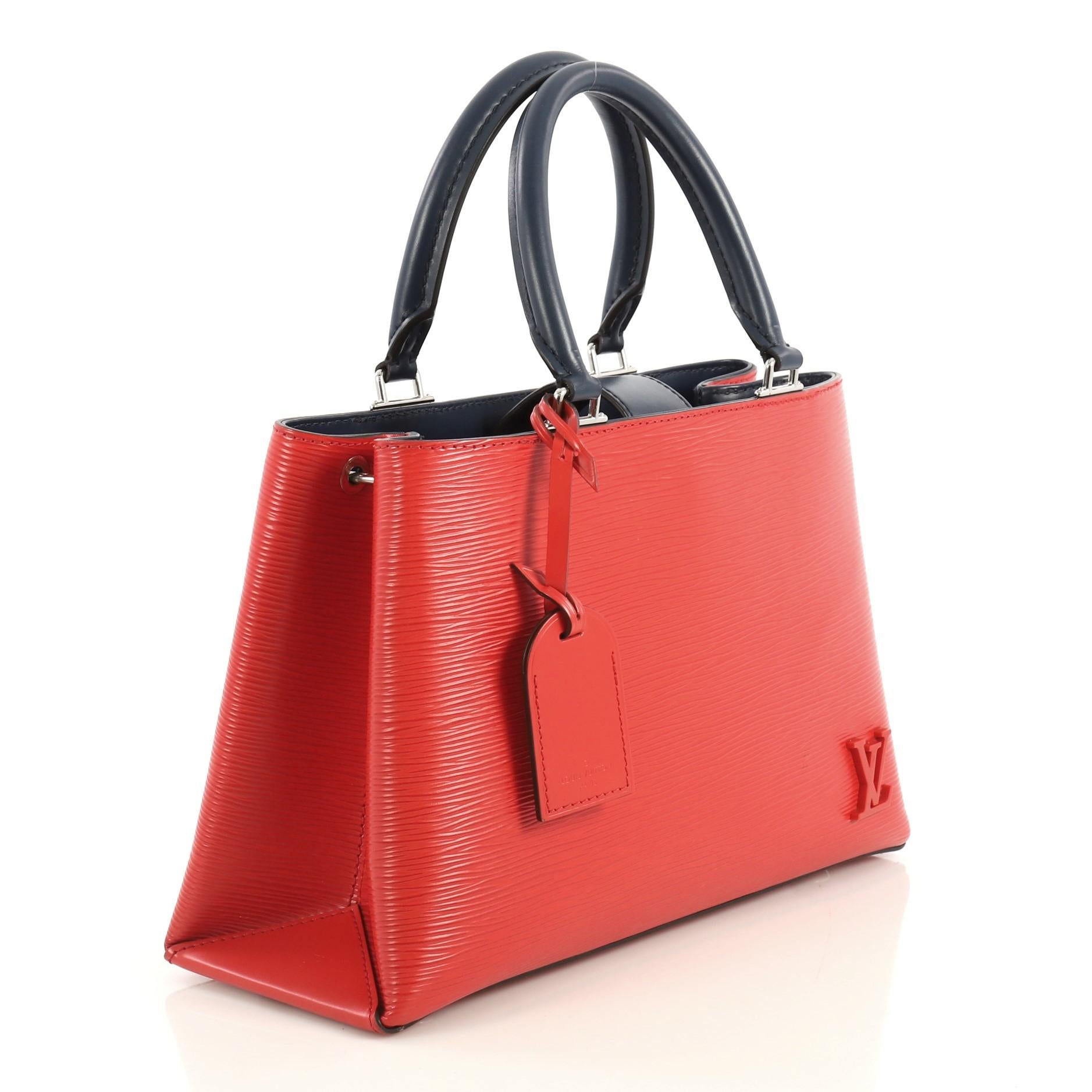 This Louis Vuitton Kleber Handbag Epi Leather PM, crafted in red epi leather, features dual rolled handles, exterior back pocket, and silver-tone hardware. Its magnetic snap closure opens to a black microfiber interior divided into two compartments