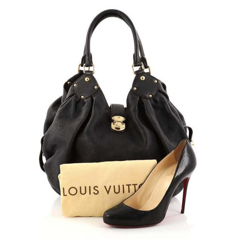 This authentic Louis Vuitton L Hobo Mahina Leather is sleek and refined in design apt for the modern woman. Crafted in black perforated monogram mahina leather, this feminine hobo features dual-rolled handles, buckle and stud details, side belt