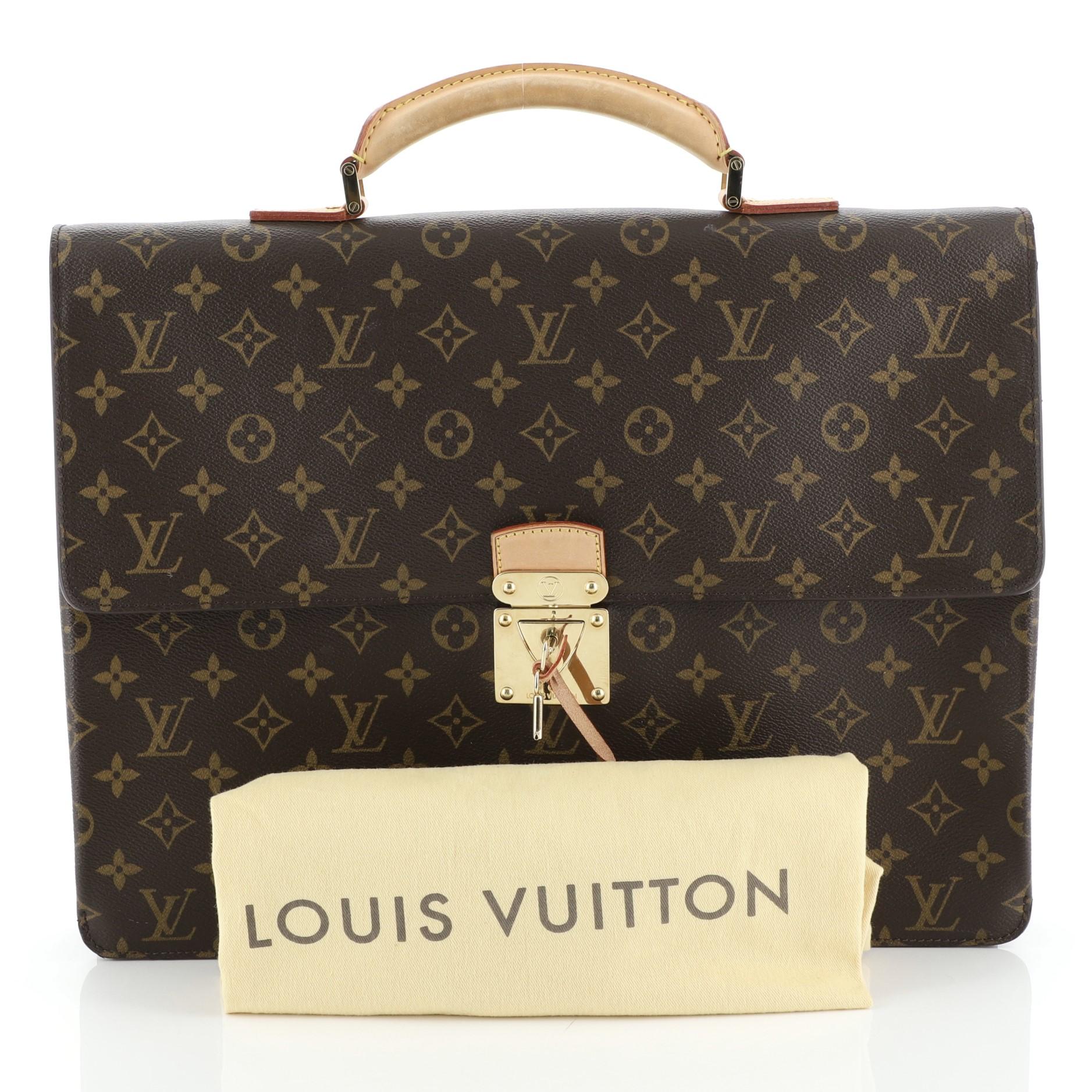 This Louis Vuitton Laguito Handbag Monogram Canvas, crafted from brown monogram coated canvas, features a leather handle, exterior back flat pocket and gold-tone hardware. Its S-lock closure opens to a brown fabric interior with zip and slip