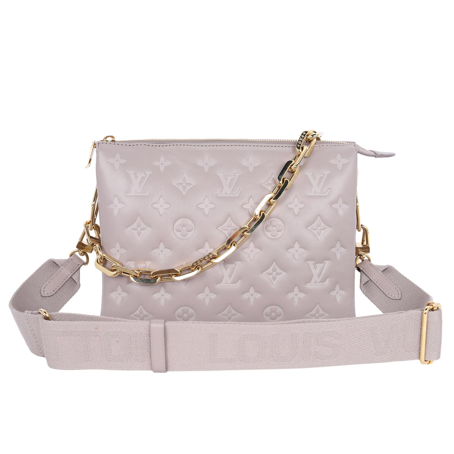 Authentic, Louis Vuitton Lambskin Embossed Monogram Coussin PM in Grey. Features soft puffy lambskin in grey and embossed with the Louis Vuitton monogram, gold hardware, zipper top closure, microfiber interior with middle zipper pocket, gold edge