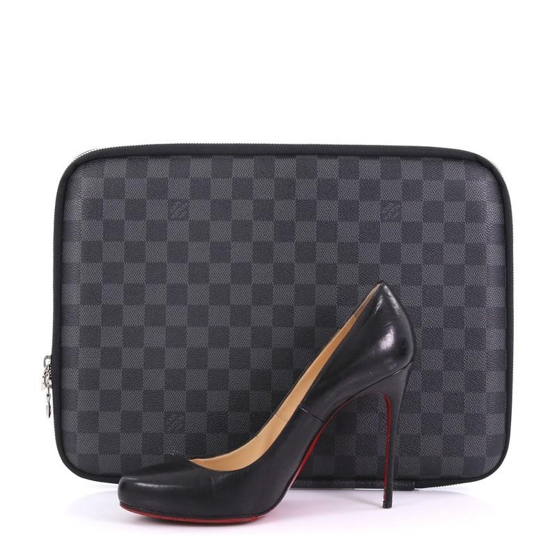 This Louis Vuitton Laptop Sleeve Damier Graphite 13, crafted from damier graphite coated canvas, features silver-tone hardware. Its all around zip closure opens to a black microfiber interior. Authenticity code reads: VI3059. **Note: Shoe