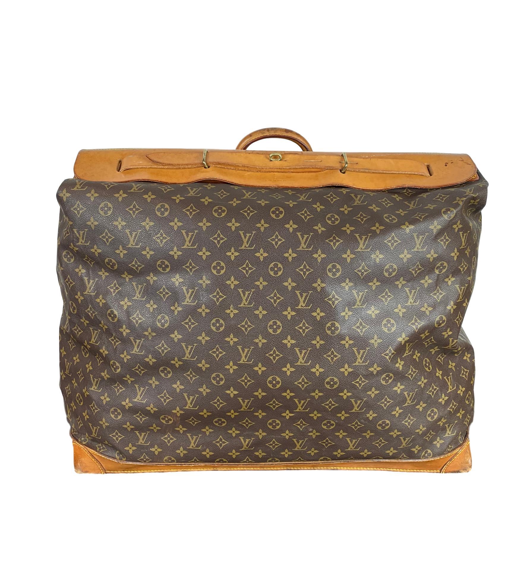 Vintage Louis Vuitton Large Monogram Steamer Travel Bag 55, France 1991. This vintage bag comes in the classic Louis Vuitton Monogram canvas with rolled top vachetta handles, making it a easy carry on item for both men and women. Interior of bag
