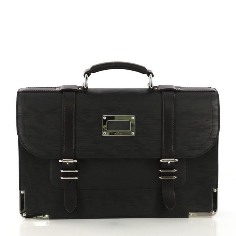 This Louis Vuitton Larry Briefcase Epi Leather, crafted from black epi leather, features top leather handle, leather trim, belt and buckle closure, metal framed edges, and silver-tone hardware. Its flap opens to a black microfiber interior.
