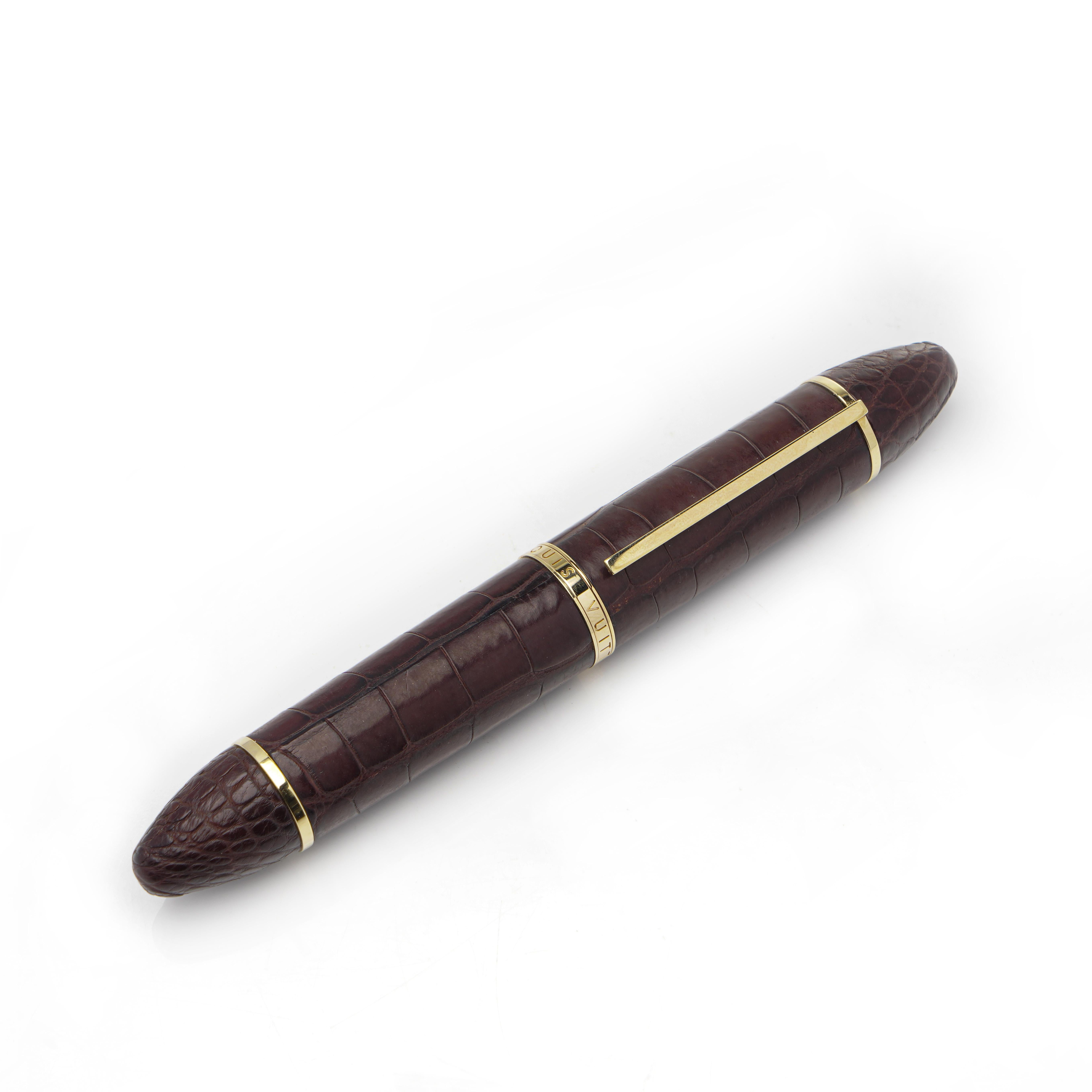 Louis Vuitton leather and 18K Gold Fountain Pen.

A luxurious Louis Vuitton fountain pen crafted with alligator leather and adorned with 18K gold accents. This exclusive writing instrument features a finely engraved Louis Vuitton 750 gold nib,