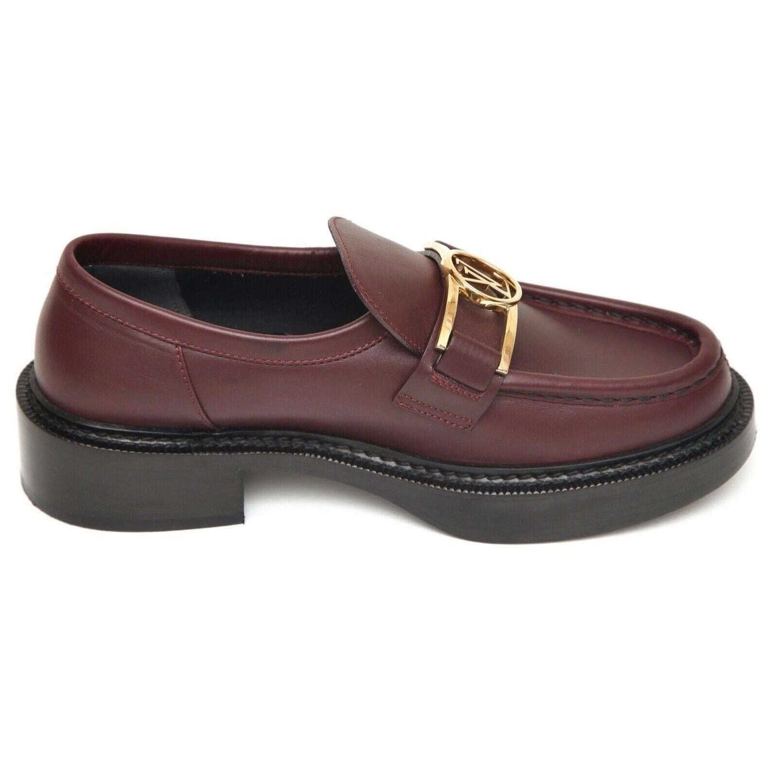 GUARANTEED AUTHENTIC LOUIS VUITTON LEATHER ACADEMY LOAFER

Retail excluding sales taxes $1,260

Details:
- ACADEMY loafer in a burgundy red leather.
- Gold-tone metal LV Dauphine over vamp.
- Slip on.
- Leather insole and sole.
- Comes with dust