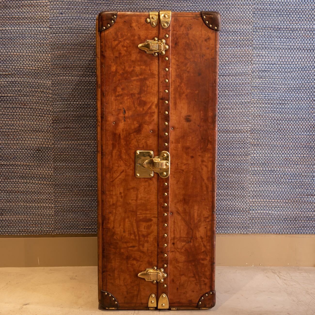 A wonderful leather covered Louis Vuitton wardrobe trunk with 50/50 internal layout of drawers with hat box and shoe compartment on one side and hanging space on the other, circa 1915.

Louis Vuitton was founded by its namesake in 1854, with the