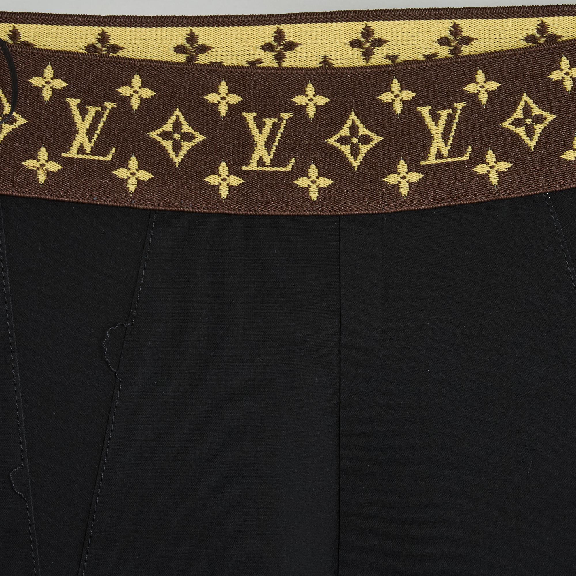 Louis Vuitton legging pants by Nicolas Ghesquière in black polyamide, mid-high waist elastic monogram-shaped belt, dark blue polyamide strip running the entire height of the crotch, side closure with a monogram-printed zip with blackened metal