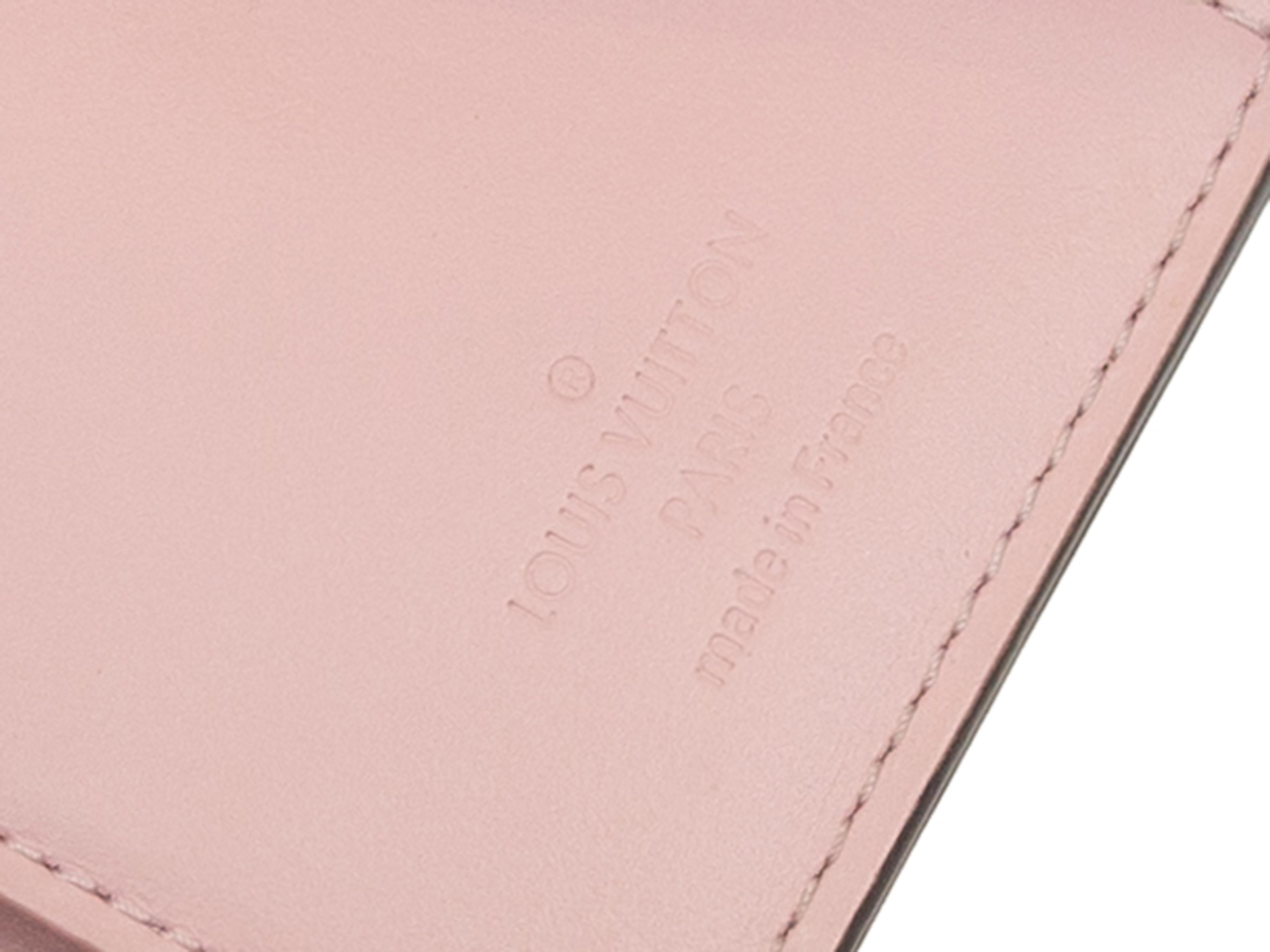 Product details: Light pink Vernis leather Victorine wallet by Louis Vuitton. Interior card and cash slots. Gold-tone hardware. 3.5