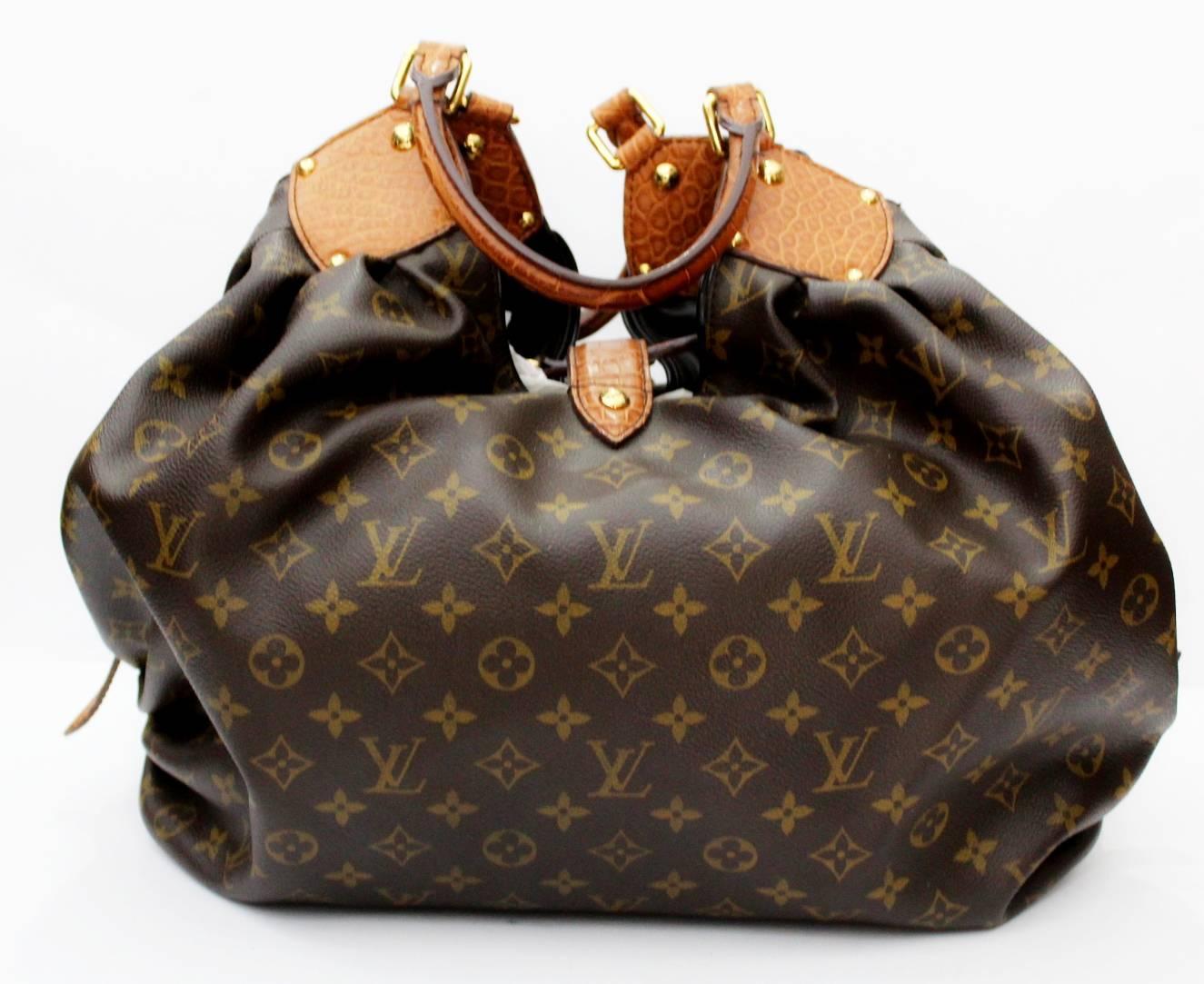 A work of art by the house of LV, this rare and hard to find Louis Vuitton Limited Edition Alligator Trim Monogram Canvas XL Bag is a true collectors item. Soft and pliable Monogram canvas is outlined with beautiful exotic Alligator trim. A matching