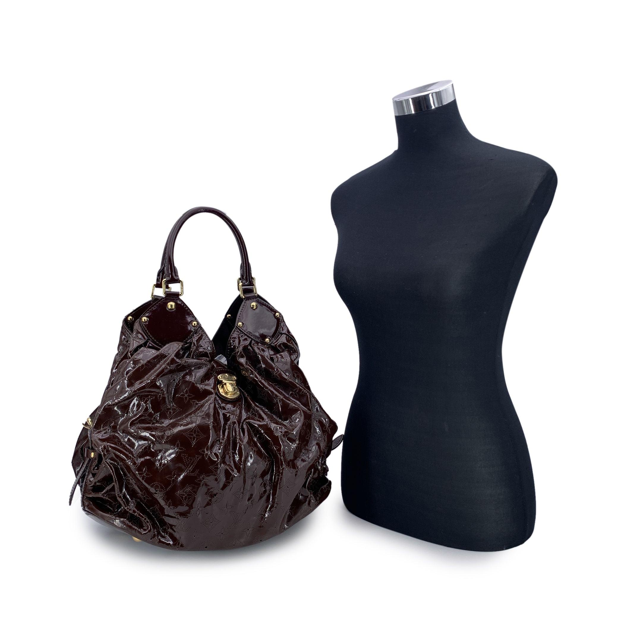 This beautiful Bag will come with a Certificate of Authenticity provided by Entrupy. The certificate will be provided at no further cost. Beautiful Vuitton Surya hobo bag, in brown patent leather with perforated monogram pattern. The name of the