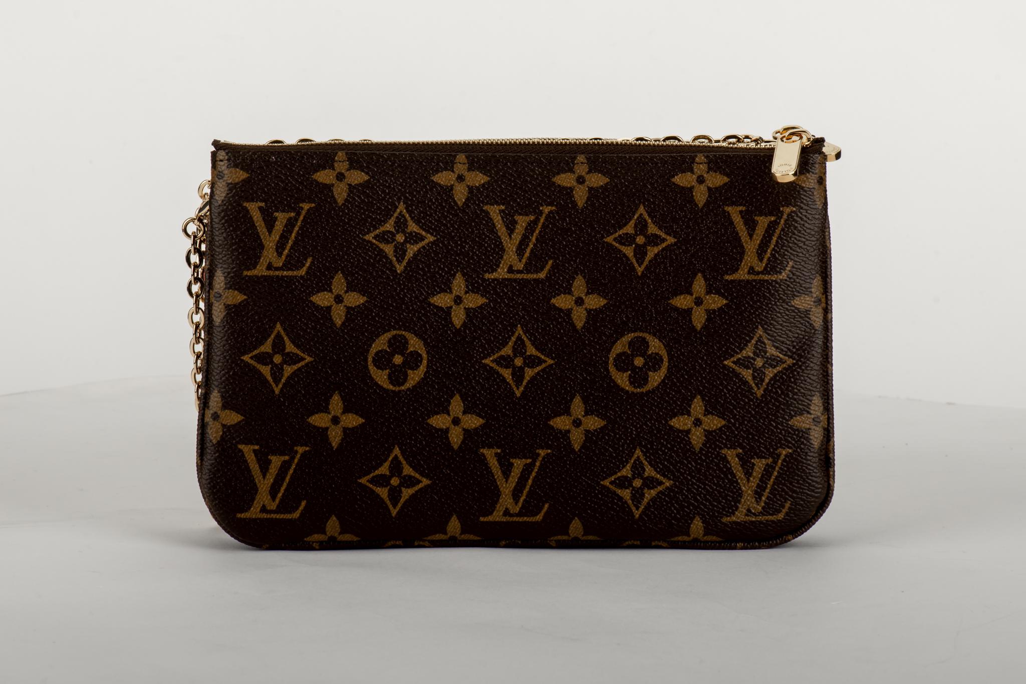 Louis Vuitton limited edition double pouchette in coated monogram canvas with Shangai Christmas design. Double zipped compartments with middle open pocket, can be used as a pouchette or as a crossbody. Comes with original dust cover and box . Never