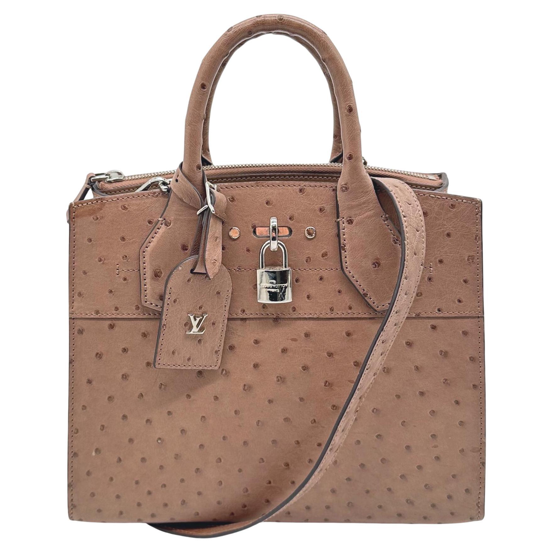 Louis Vuitton Limited Edition Gris Ostrich City Steamer PM Top Handle Bag, 2021. This steamer bag is a classic Louis Vuitton closet staple which was first introduced and designed by Nicolas Ghesquière for cruise-ship passengers in 1901. Since its