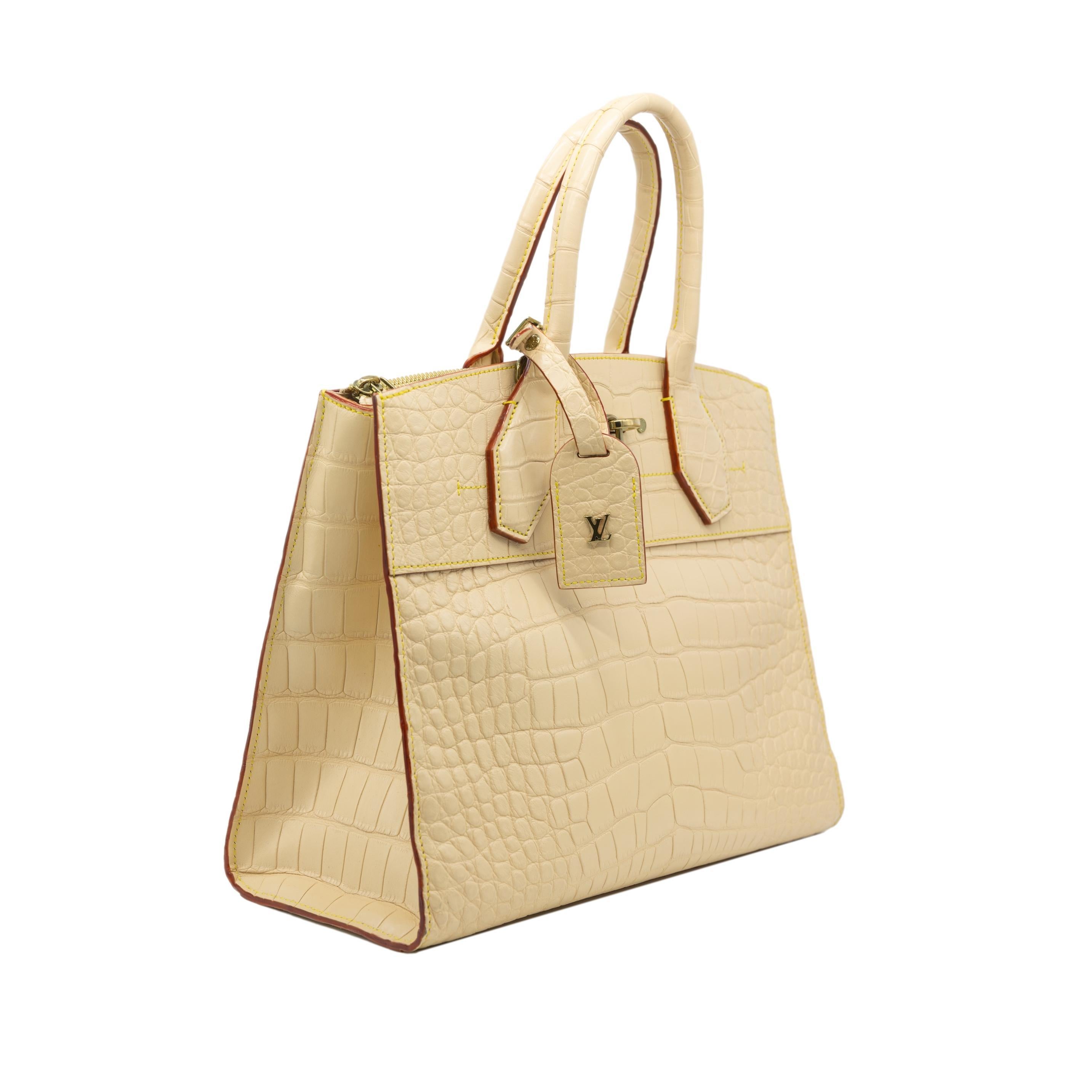 Louis Vuitton Limited Edition Matte Vanilla Alligator Top Handle City Steamer MM Bag, 2015. This  steamer bag is a classic Louis Vuitton closet staple which was first introduced and designed by Nicolas Ghesquière for cruise-ship passengers in 1901.