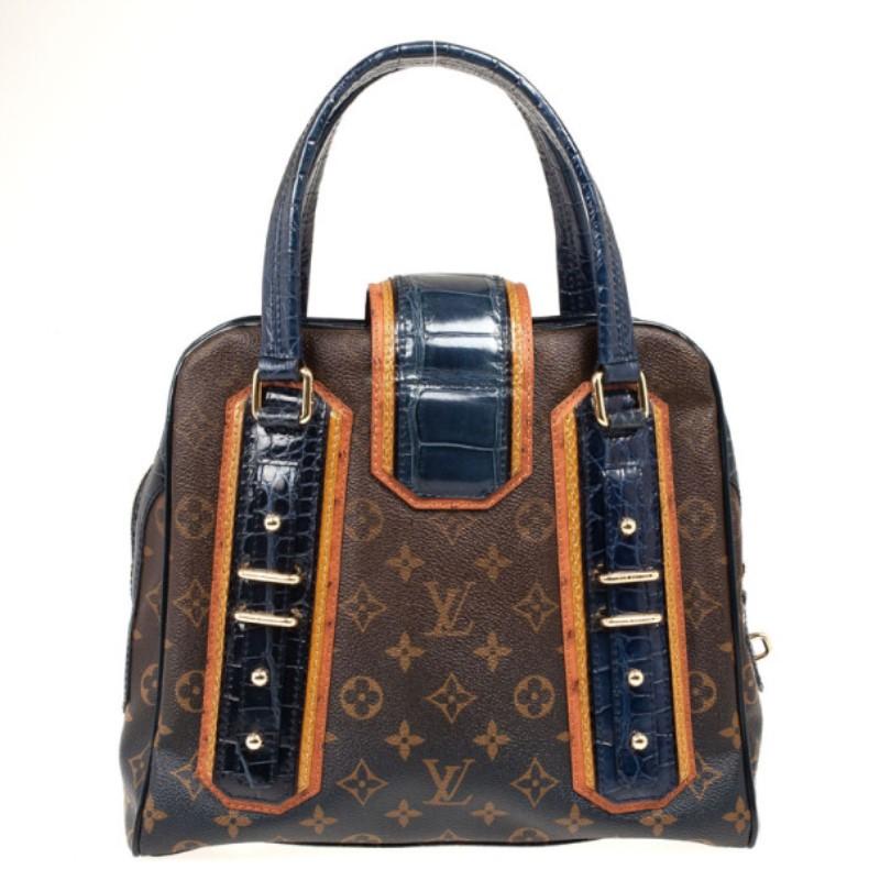 Feast your eyes on this limited edition Mirage from the 2007 Fall Louis Vuitton collection. This luscious satchel is made from light brown ostrich trim details, Monogram mirage canvas that fades to blue, navy alligator and mustard snakeskin. It is