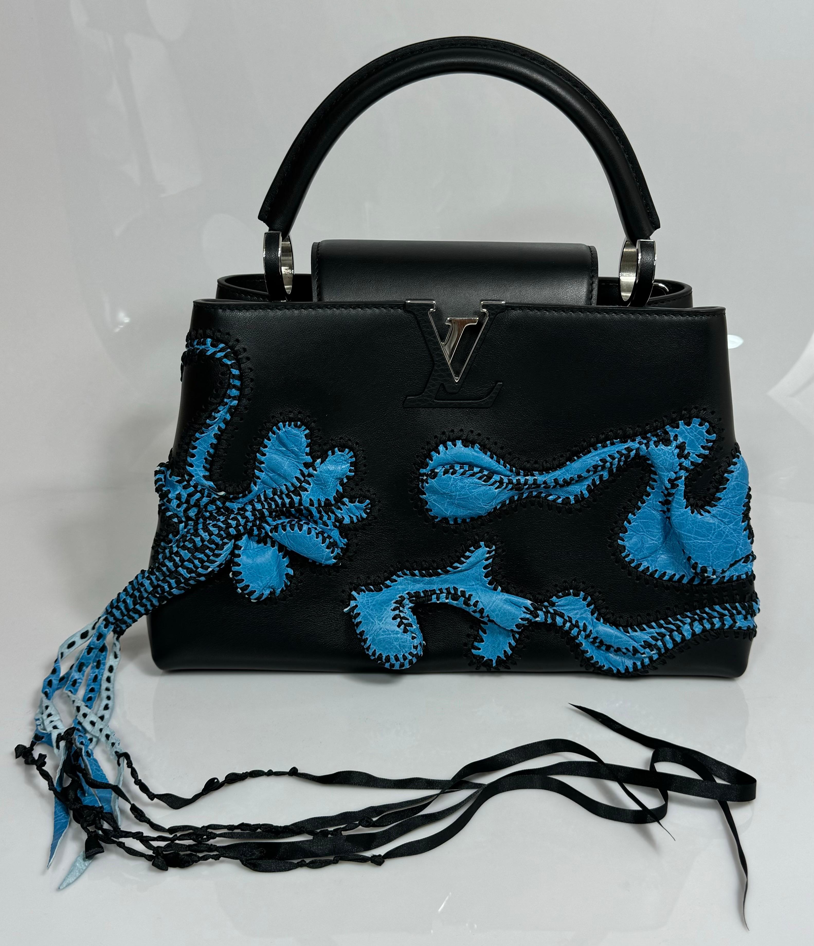 Louis Vuitton Limited Edition Nicholas Hlobo's Artycapucines Handbag-NEW IN BOX
This brand new Louis Vuitton Nicholas Hlobo Limited Edition Artycapucines handbag is made of black and blue calfskin leather with cowhide leather lining. Featuring blue