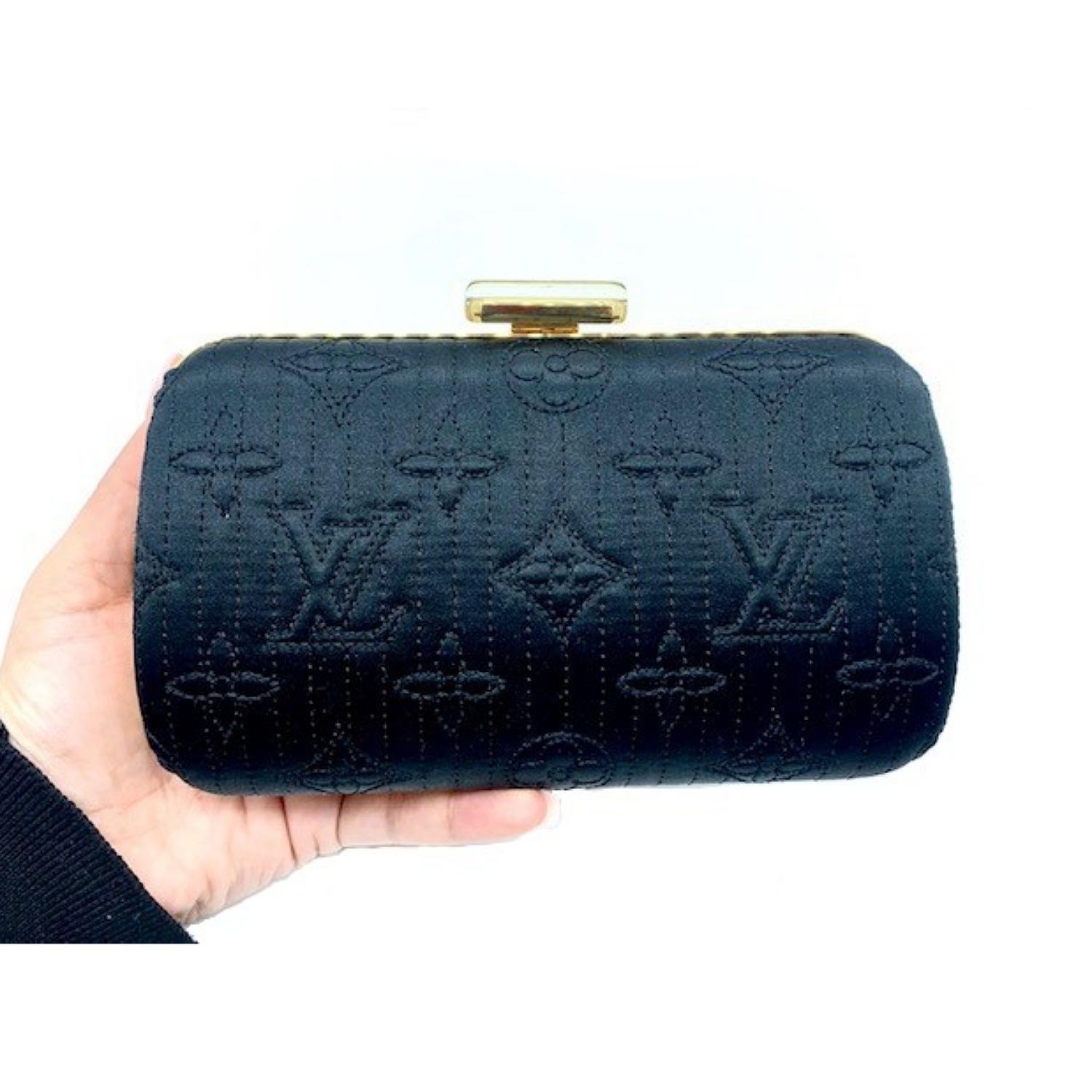 Louis Vuitton Noir Monogram Minaudiere Motard Clutch Bag is a limited edition stunning evening bag for any classy event. It features LV monogram quilted satin in black with a gold chain shoulder strap. Wear it over your shoulder or as a clutch. Open