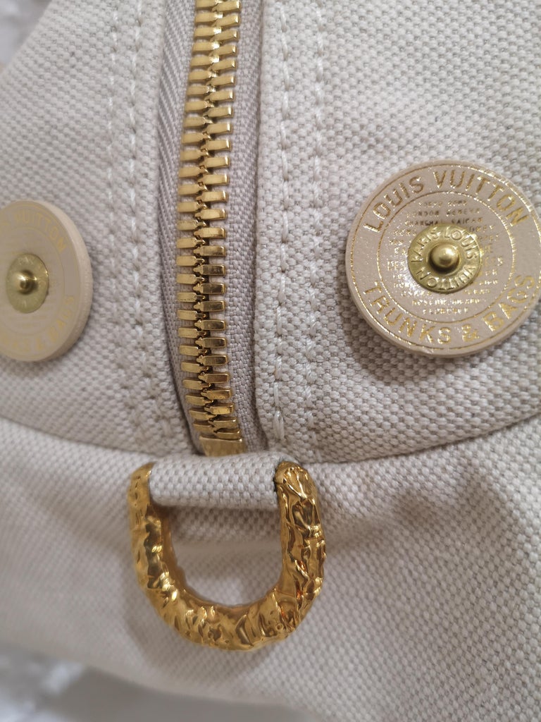 Louis Vuitton limited edition shoulder handle bag
embellished with leather circle all around and gold tone hardware and gold working bells
