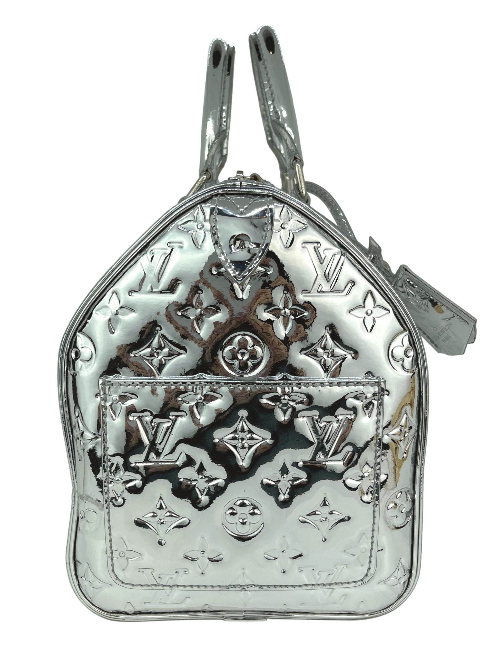 Louis Vuitton Limited Edition Silver Monogram Miroir Top Handle Speedy 30, 2006. The iconic speedy was first introduced in the 1930's and was designed as an alternative for the larger 