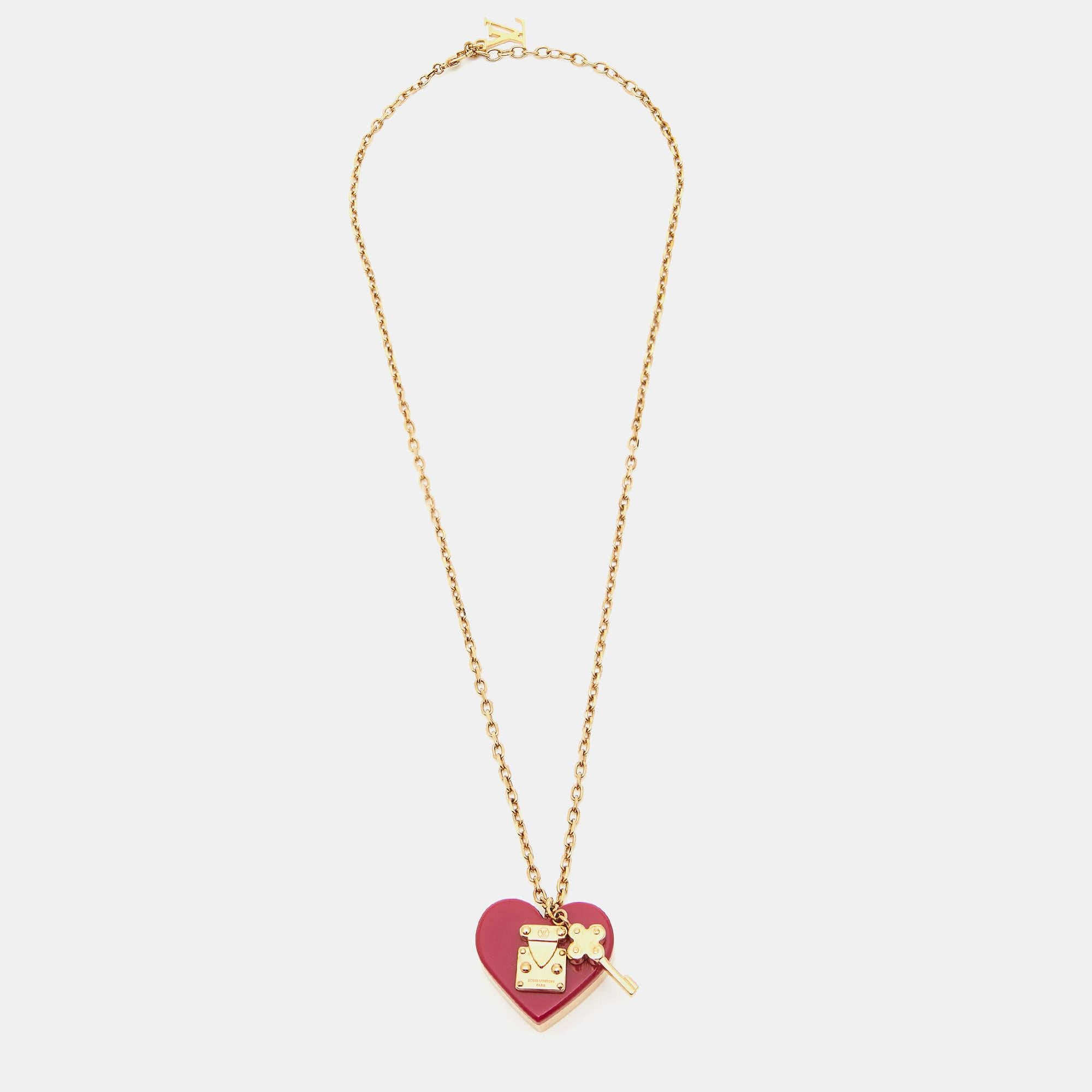 This lovely pendant necklace from Louis Vuitton is sure to become one of your favorite accessories! It comes crafted from gold-tone metal, and the chain carries a heart lock and key pendant.

