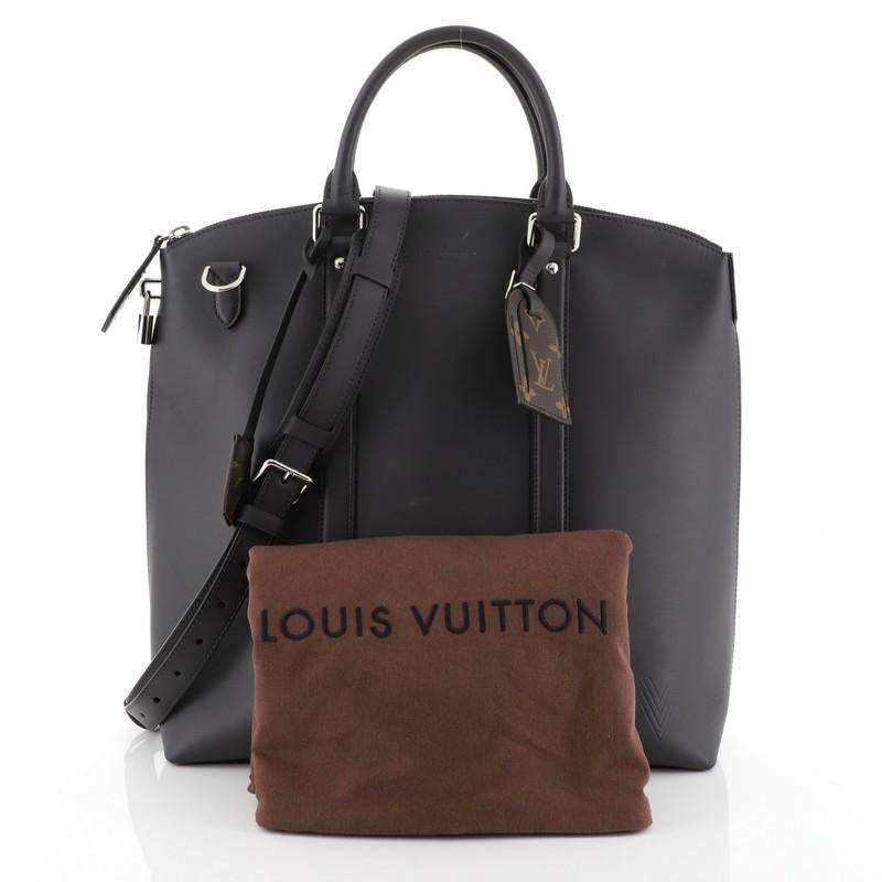 This Louis Vuitton Lockit Ombre Tote Leather, crafted in gray leather, features dual rolled handles and silver-tone hardware. Its zip closure opens to a black microfiber interior. Authenticity code reads: RI4155. 

Estimated Retail Price: