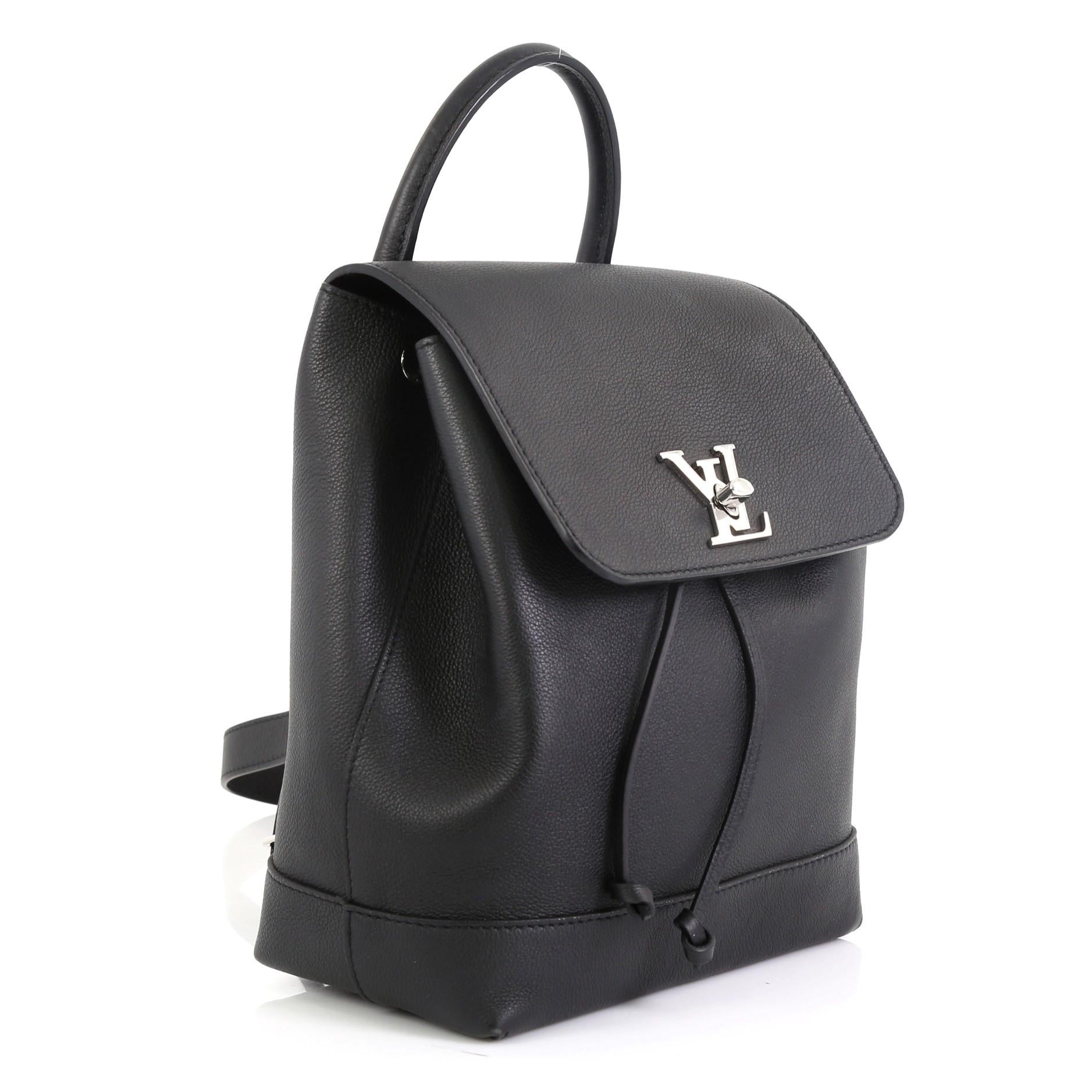 This Louis Vuitton Lockme Backpack Leather, crafted in black leather, features a leather top handle, adjustable shoulder straps, and silver-tone hardware. Its turn-lock and drawstring closure opens to a black microfiber interior with slip pocket.