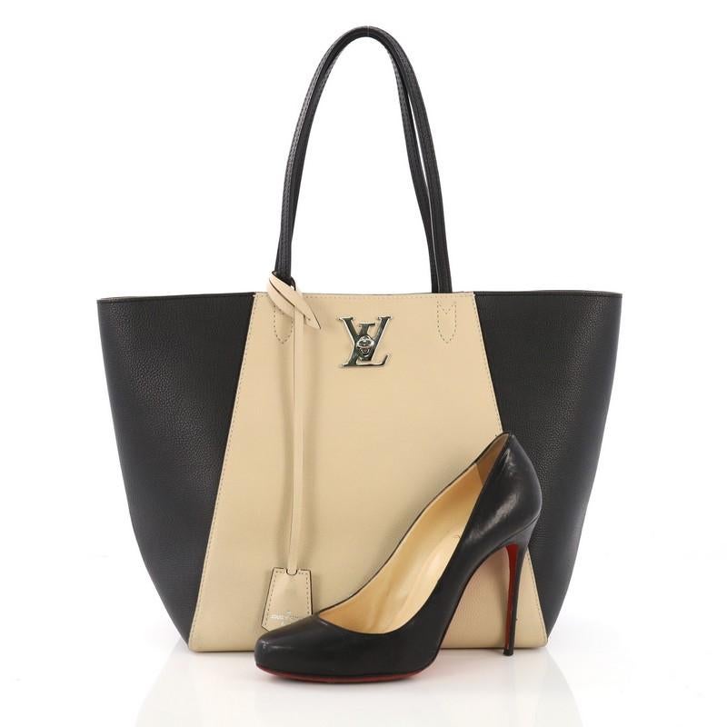 This Louis Vuitton Lockme Cabas Leather, crafted from beige and black leather, features dual flat leather handles and silver-tone hardware. Its turn-lock closure opens to a beige microfiber interior with zip and slip pockets. Authenticity code