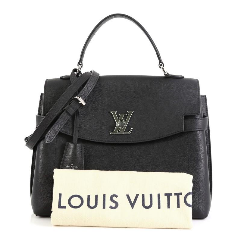 This Louis Vuitton Lockme Ever Handbag Leather MM, crafted in black leather, features a single loop leather handle and silver-tone hardware. Its flap with turn-lock closure opens to a black microfiber interior with slip pockets. Authenticity code