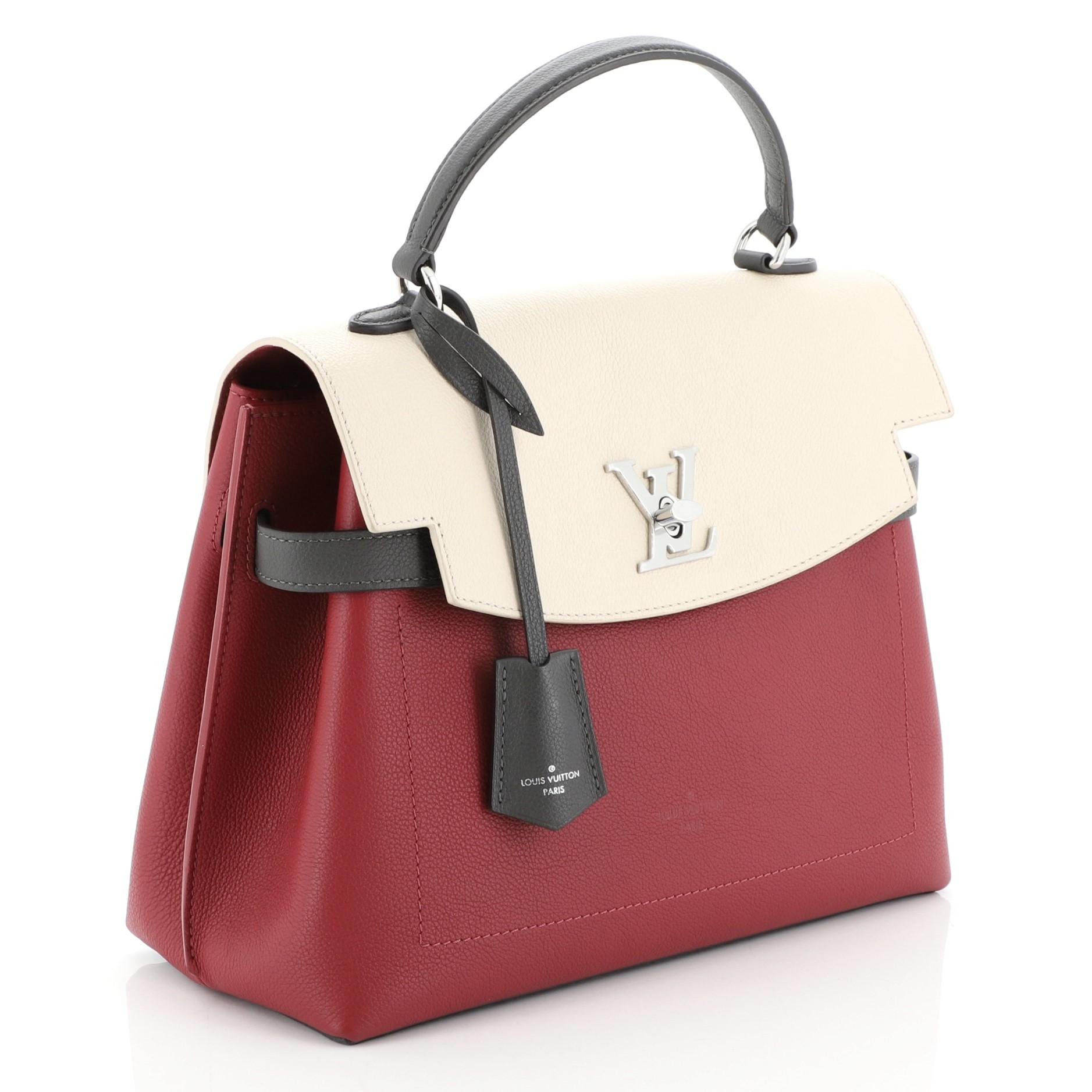 This Louis Vuitton Lockme Ever Handbag Leather MM, crafted in gray, neutral, and red leather, features a single loop leather handle and silver-tone hardware. Its flap with turn-lock closure opens to a red microfiber interior with slip pockets.