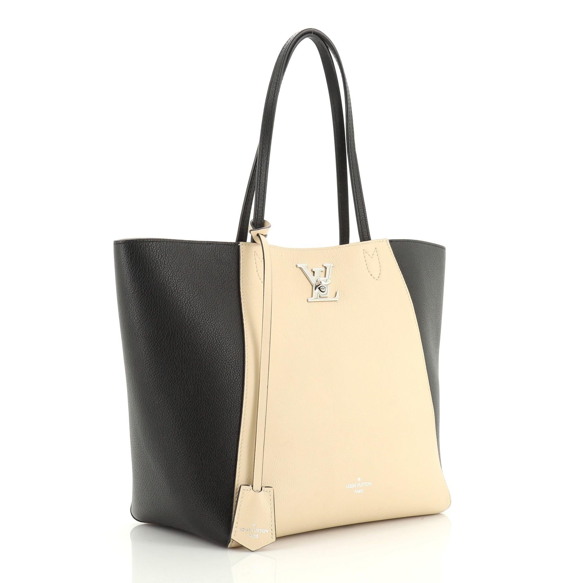 This Louis Vuitton Lockme Cabas Leather, crafted from black and neutral leather, features dual slim leather handles and silver-tone hardware. Its LV turn-lock closure opens to a neutral microfiber interior with zip and slip pockets. Authenticity