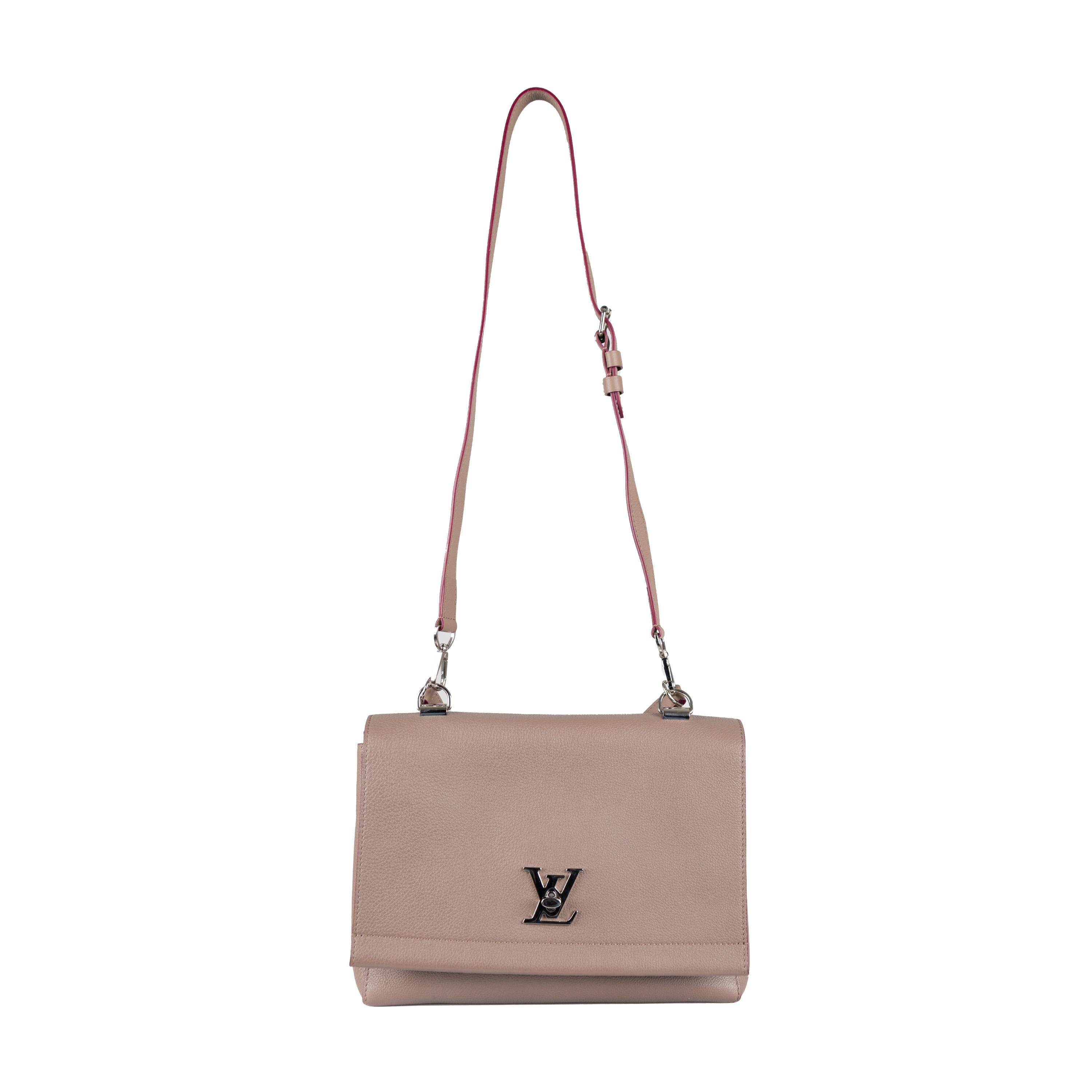 This top handle bag from Louis Vuitton's Spring 2015 collection is an updated version of the original Lockme bag. Crafted from superior quality mink color leather, it features the iconic LV Twist closure in shiny silver-tone metal.  Enjoy enhanced