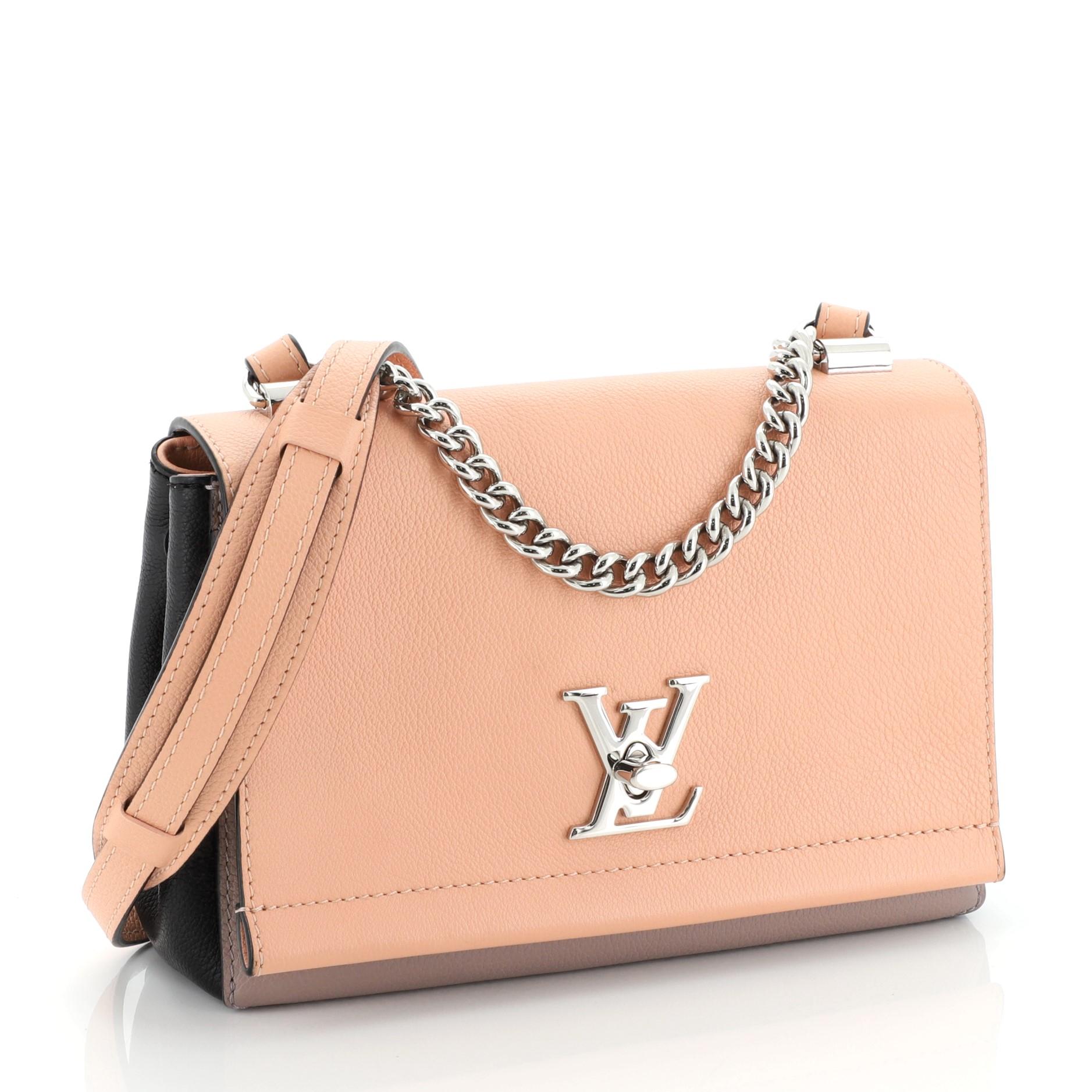 This Louis Vuitton Lockme II Handbag Leather BB, crafted in pink and multicolor leather, features chain link strap with leather pad, exterior back zip pocket, slip pocket under flap, and silver-tone hardware. Its LV twist-lock closure opens to a