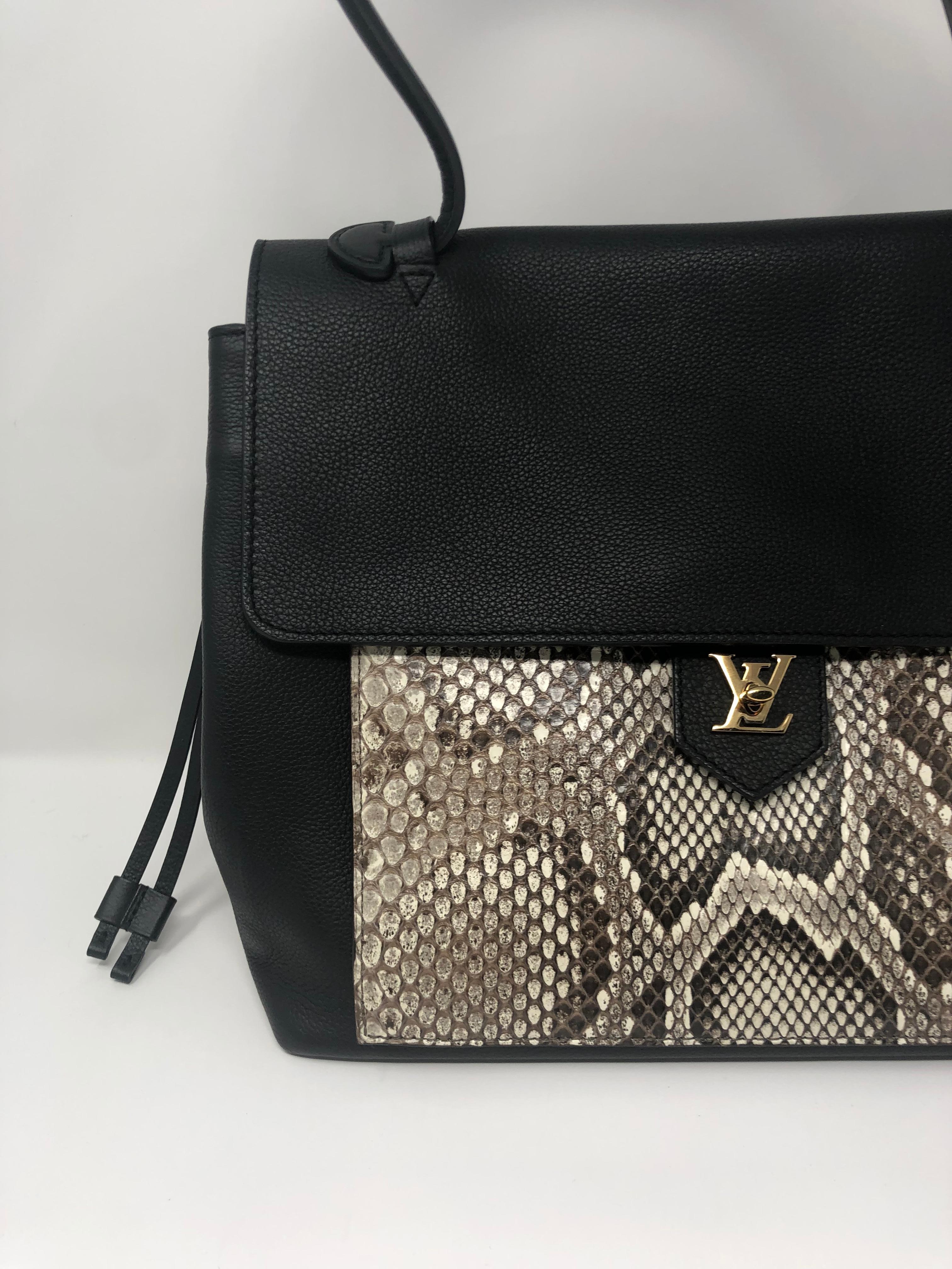 Louis Vuitton Calfskin Python Lockme MM in black leather. Beautiful python with black leather makes this bag a showstopper. LV turn lock on front of bag still has plastic on the inside. Never used. Bag is like new condition. The perfect size tote to