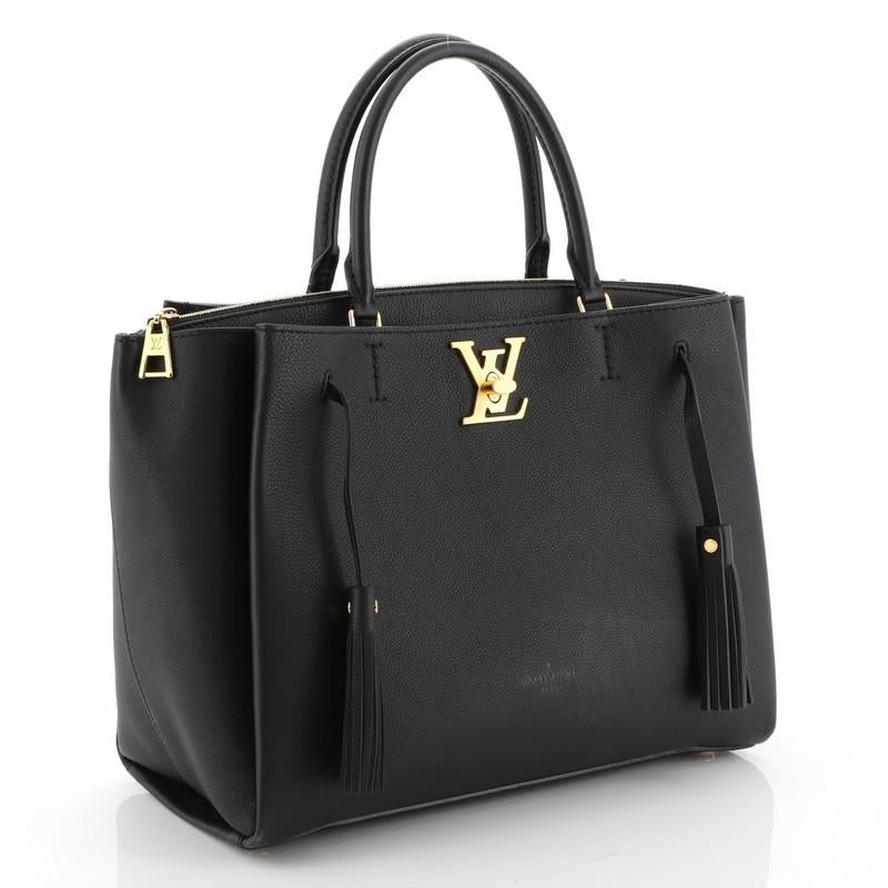 This Louis Vuitton Lockmeto Handbag Leather, crafted from black leather, features dual rolled leather handles, front compartment with LV turn-lock closure and gold-tone hardware. It opens to a black microfiber interior. Authenticity code reads: