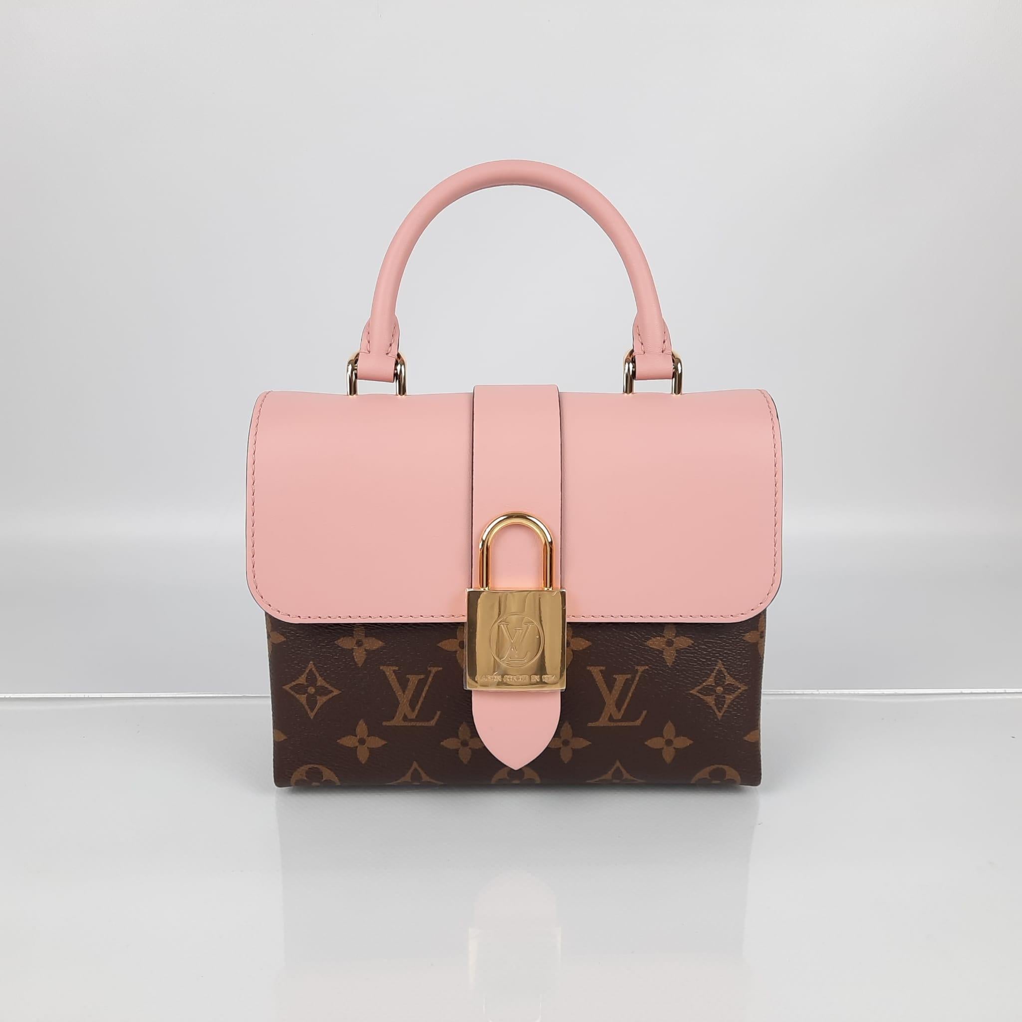  The Locky BB bag with a rigid structure is made of monogram canvas and cowhide, and it shows off an oversize metallic LV padlock closure in gold, which adds elegance and originality to the design. It is perfect to wear both during the day and at