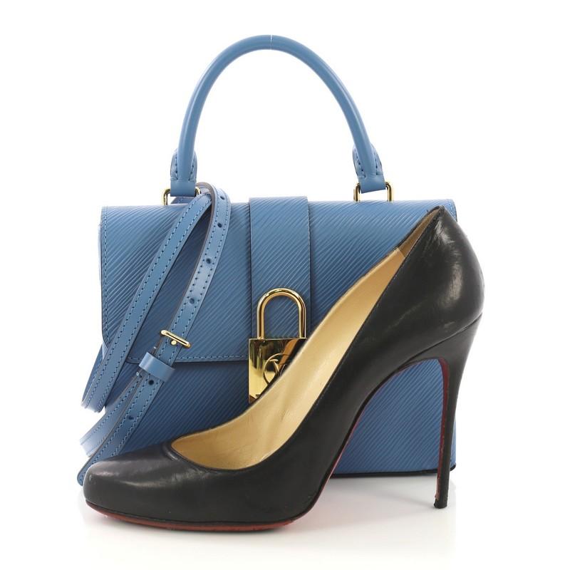 This Louis Vuitton Locky Top Handle Bag Epi Leather BB, crafted in blue epi leather, features a rolled top handle, adjustable strap for shoulder or cross-body carry and gold-tone hardware. Its LV padlock closure opens to a blue microfiber interior