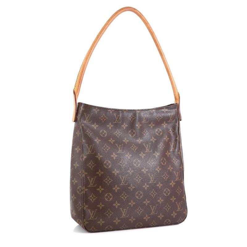 This Louis Vuitton Looping Handbag Monogram Canvas GM, crafted from brown monogram coated canvas, features an arched natural vachetta leather handle and gold-tone hardware. Its zip closure opens to a neutral microfiber interior with zip and slip