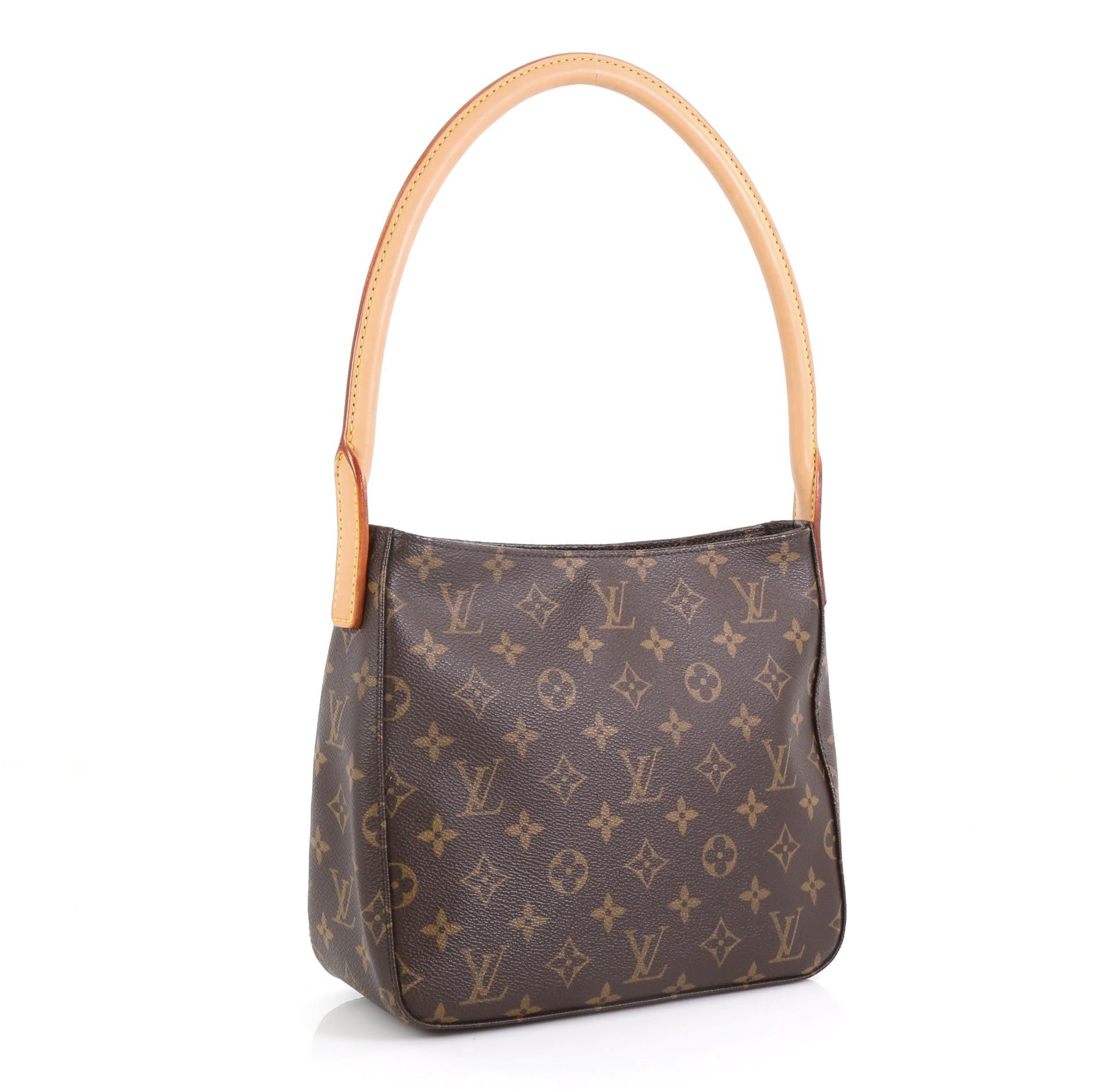 This Louis Vuitton Looping Handbag Monogram Canvas MM, crafted from brown monogram coated canvas, features a thick vachetta cowhide looped strap and gold-tone hardware. Its zip closure opens to a neutral microfiber interior with zip and slip