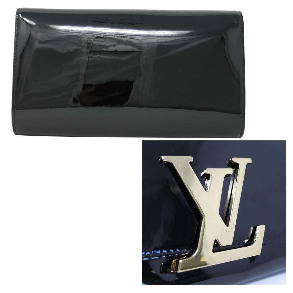 Brand: Louis Vuitton
Style: Clutch
Handles: No Handles
Measurements: 10″ x 1.75″ x 6″
Materials: Black Patent Leather 
Hardware & Lining: Gold Tone Hardware, Black textile lining
Interior: 6 Card Compartments, 1 Zippered Compartment
Exterior: No