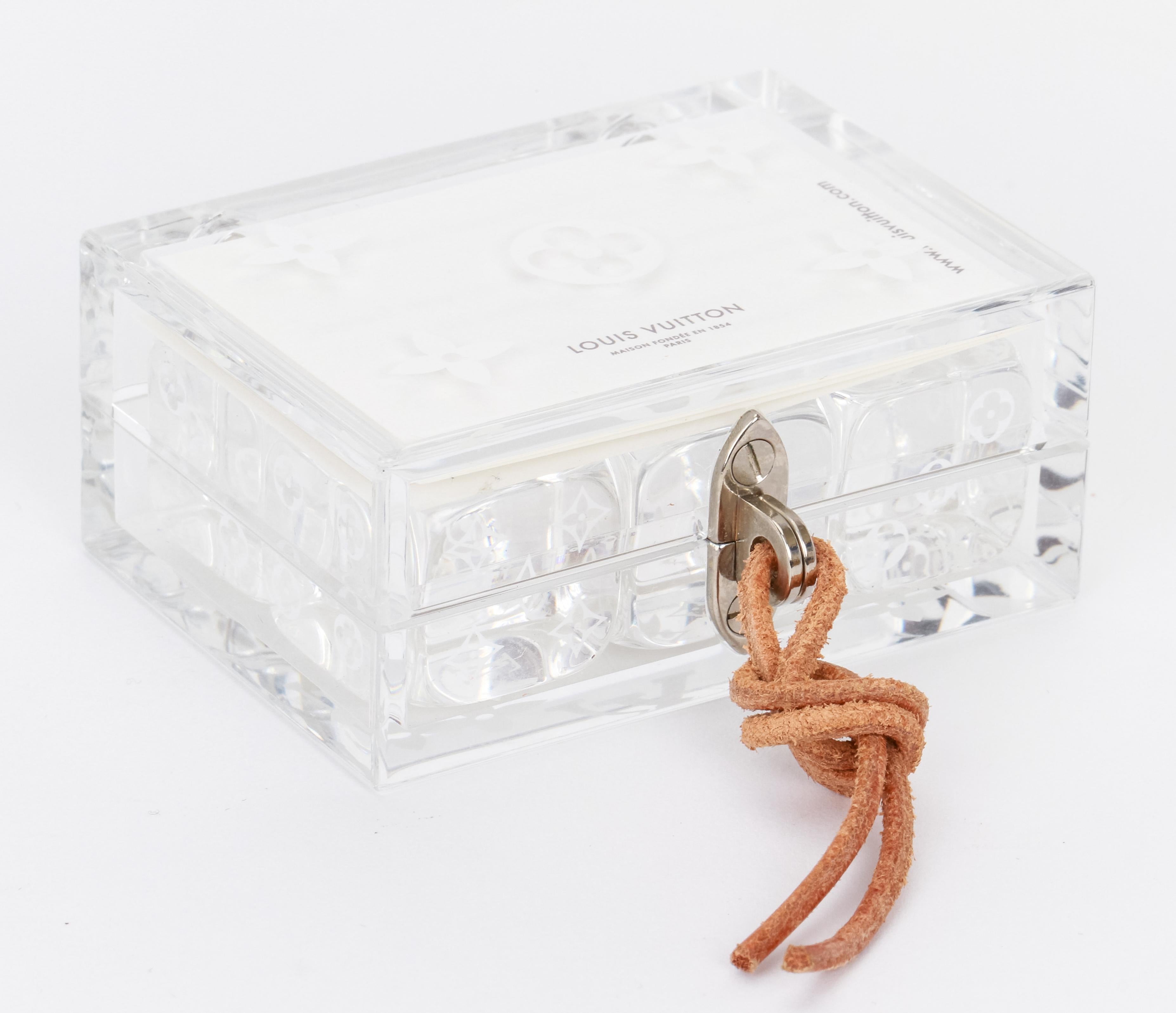 Louis Vuitton lucite case with set of six dice, metal clasp, leather string