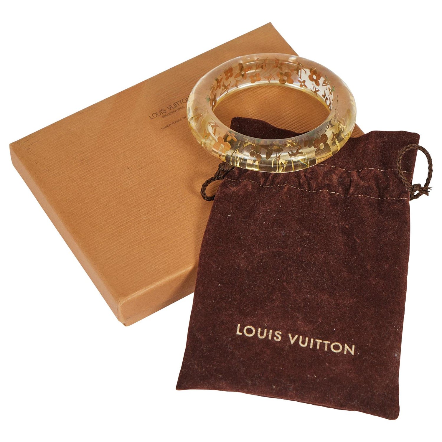 A LOUIS VUITTON LUCITE AND GOLD LEAF RING, the bombe style clear coloured  ring inset with gold leaf details including initials LV and flower head  details. In Louis Vuitton box. Ring size