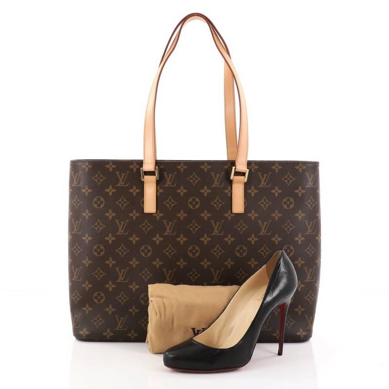 This authentic Louis Vuitton Luco Handbag Monogram Canvas is a classic tote that displays fashion and functionality all rolled into one. Crafted with the brand's iconic brown monogram coated canvas, this tote features dual flat leather handles, a