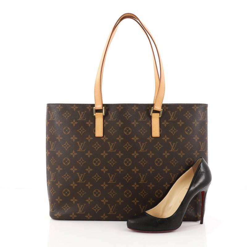 This authentic Louis Vuitton Luco Handbag Monogram Canvas is a classic tote that displays fashion and functionality all rolled into one. Crafted with brand's iconic brown monogram coated canvas, this tote features dual flat leather handles, a sturdy