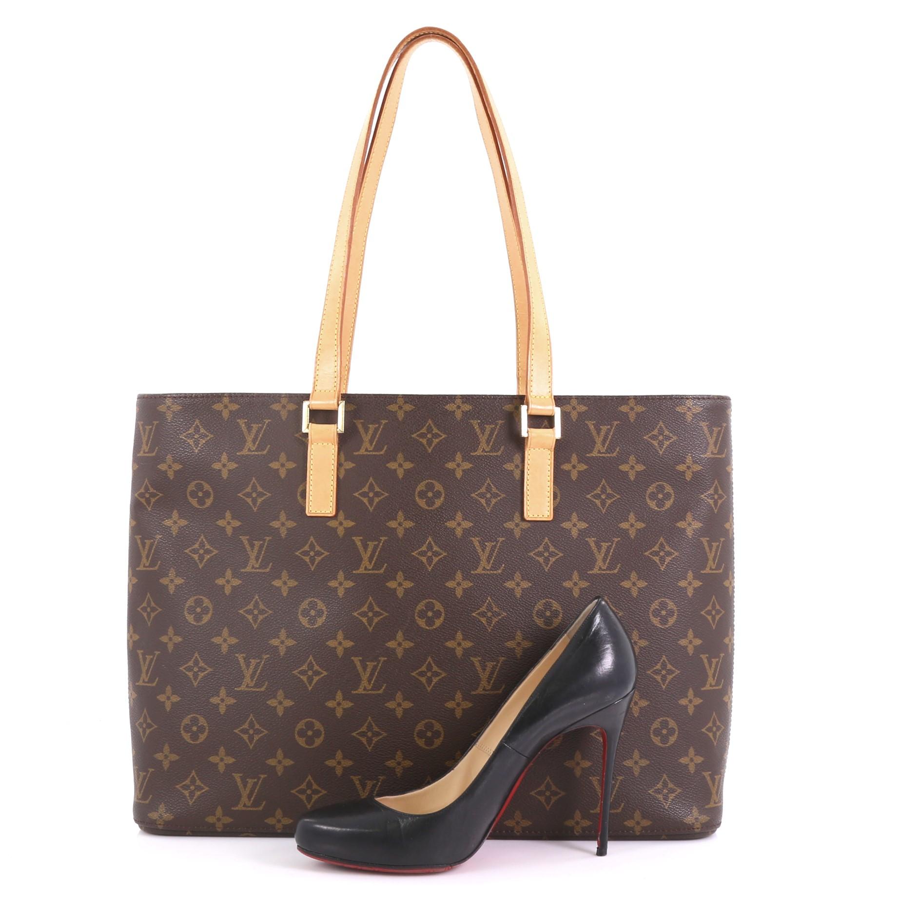 This Louis Vuitton Luco Handbag Monogram Canvas, crafted in brown monogram coated canvas, features dual flat leather handles and gold-tone hardware. Its zip closure opens to a beige microfiber interior with zip and slip pockets. Authenticity code