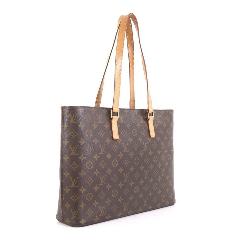 This Louis Vuitton Luco Handbag Monogram Canvas, crafted in brown monogram coated canvas, features dual flat leather handles and gold-tone hardware. Its zip closure opens to a neutral microfiber interior with zip and slip pockets. Authenticity code