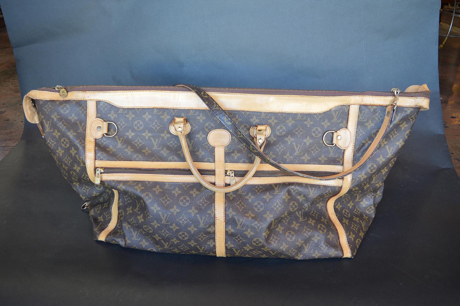 Set of two soft Luis Vuitton luggage.
Duffle bag measures 37 inches W x 18 inches H.