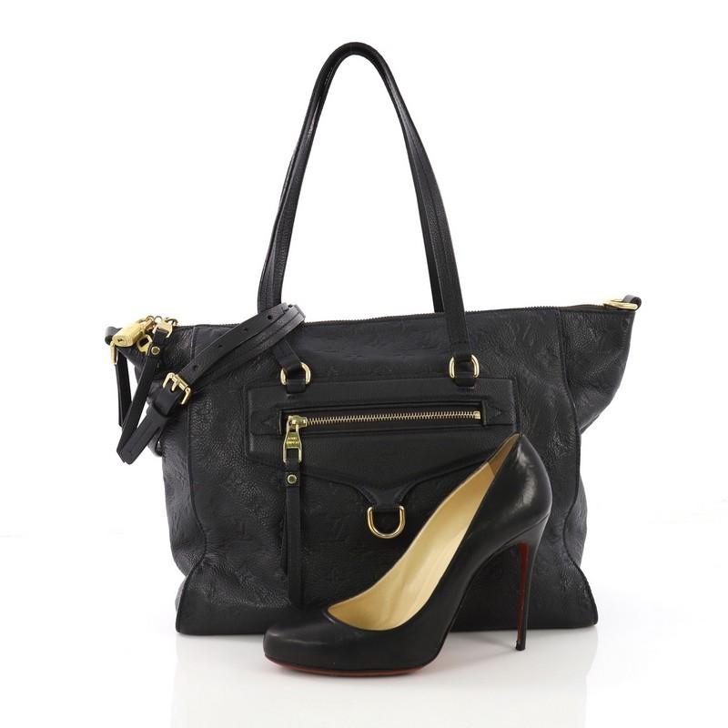 This Louis Vuitton Lumineuse Handbag Monogram Empreinte Leather PM, crafted in navy monogram empreinte leather, features an exterior front zip pocket, dual flat handles, and gold-tone hardware. Its top zip closure opens to a blue fabric interior