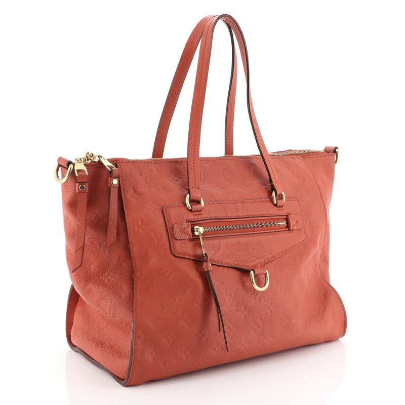 This Louis Vuitton Lumineuse Handbag Monogram Empreinte Leather PM, crafted in red monogram empreinte leather, features dual flat handles, exterior front zip pocket, and gold-tone hardware. Its top zip closure opens to a red fabric interior with zip