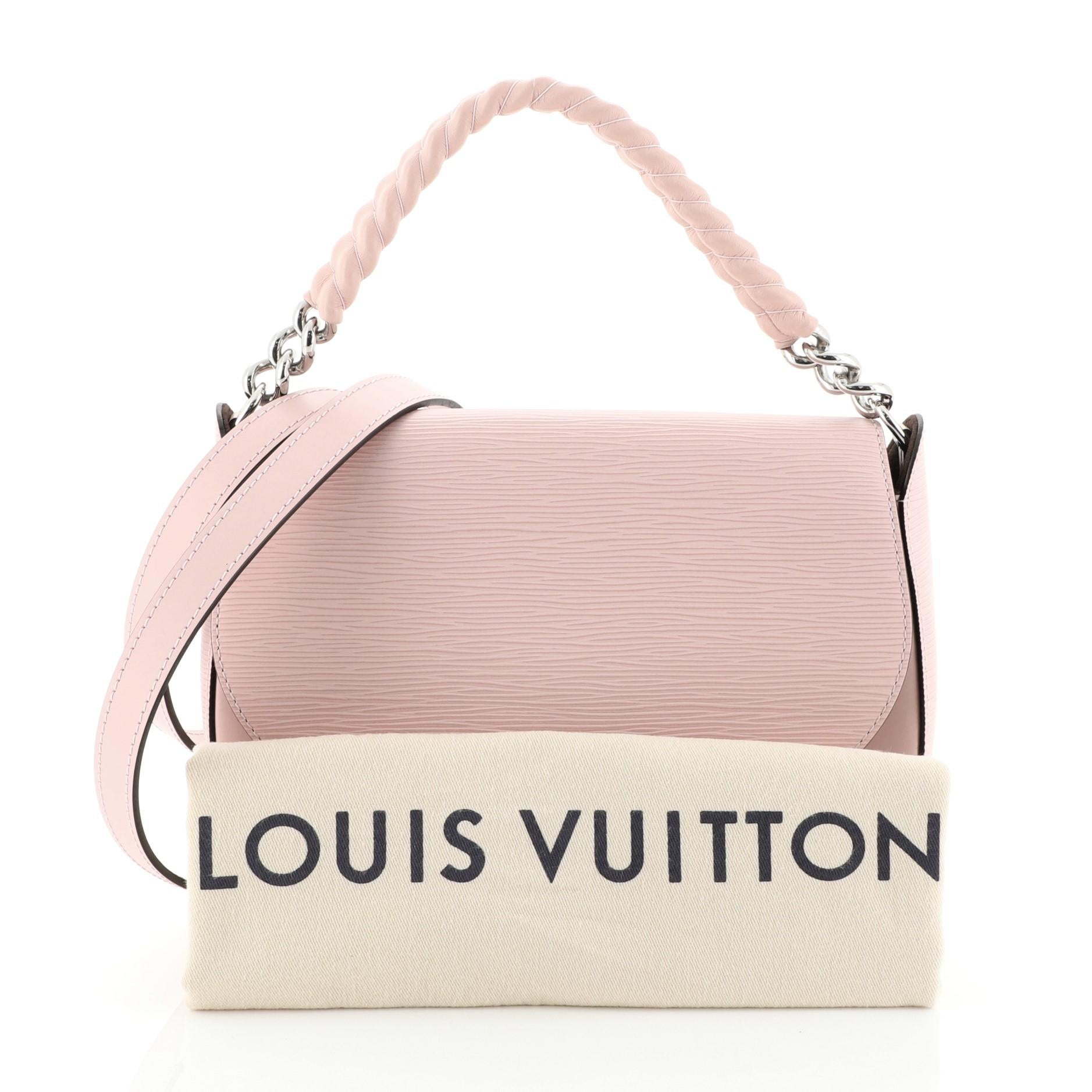 This Louis Vuitton Luna Handbag Epi Leather, crafted in pink epi leather, features a structured and sleek shape, chain-link handle covered in sheepskin, detachable strap, LV signature logo at front and silver-tone hardware. Its magnetic snap button