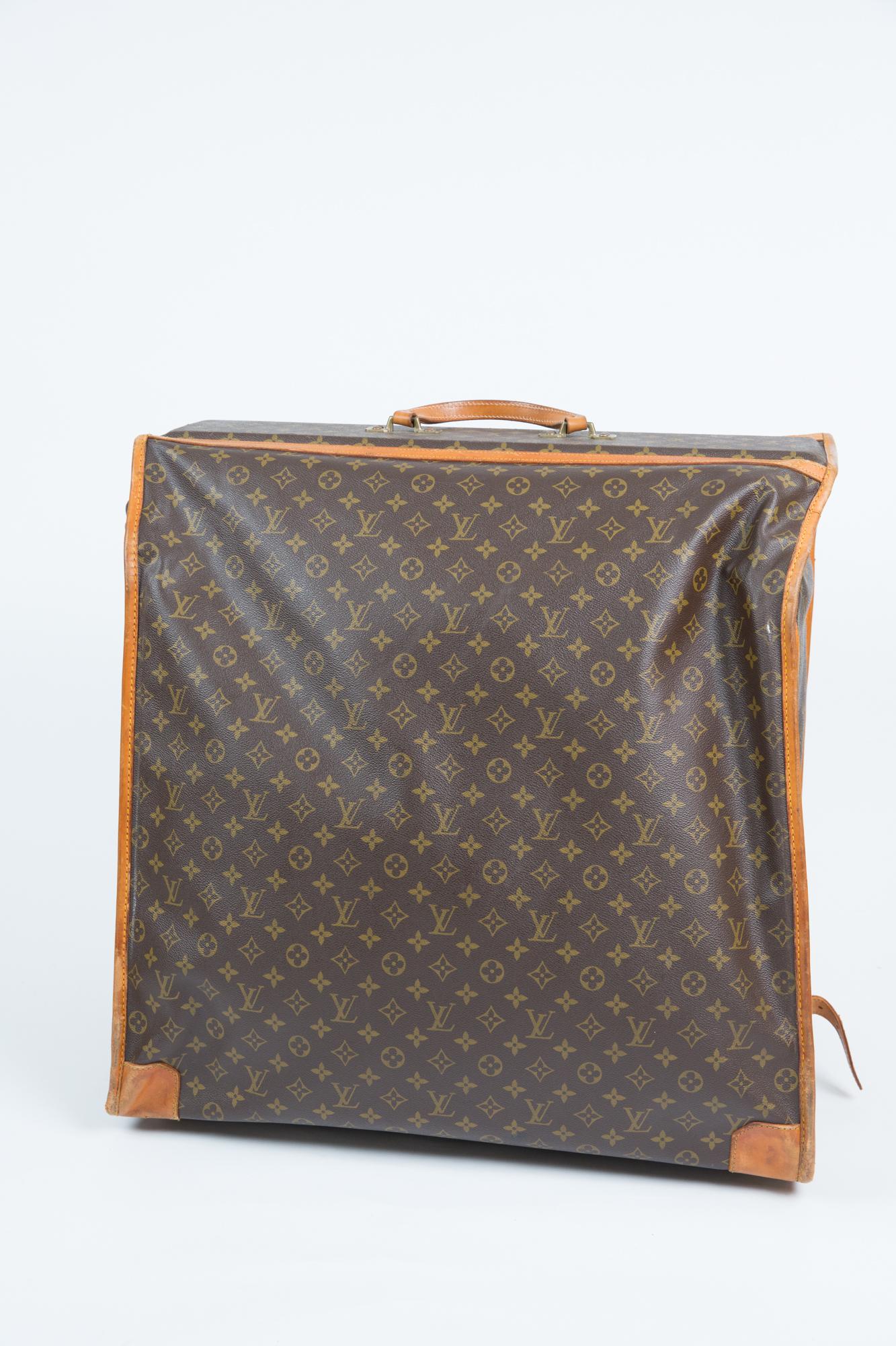 Louis Vuitton brown Monogram clothes-hangers luggage featuring a monogram canvas and natural leather, hardware in gilt metal, simple handle in leather allowing the bag to be worn in the hand, zip closure and swirling fastener.
One large zip pocket